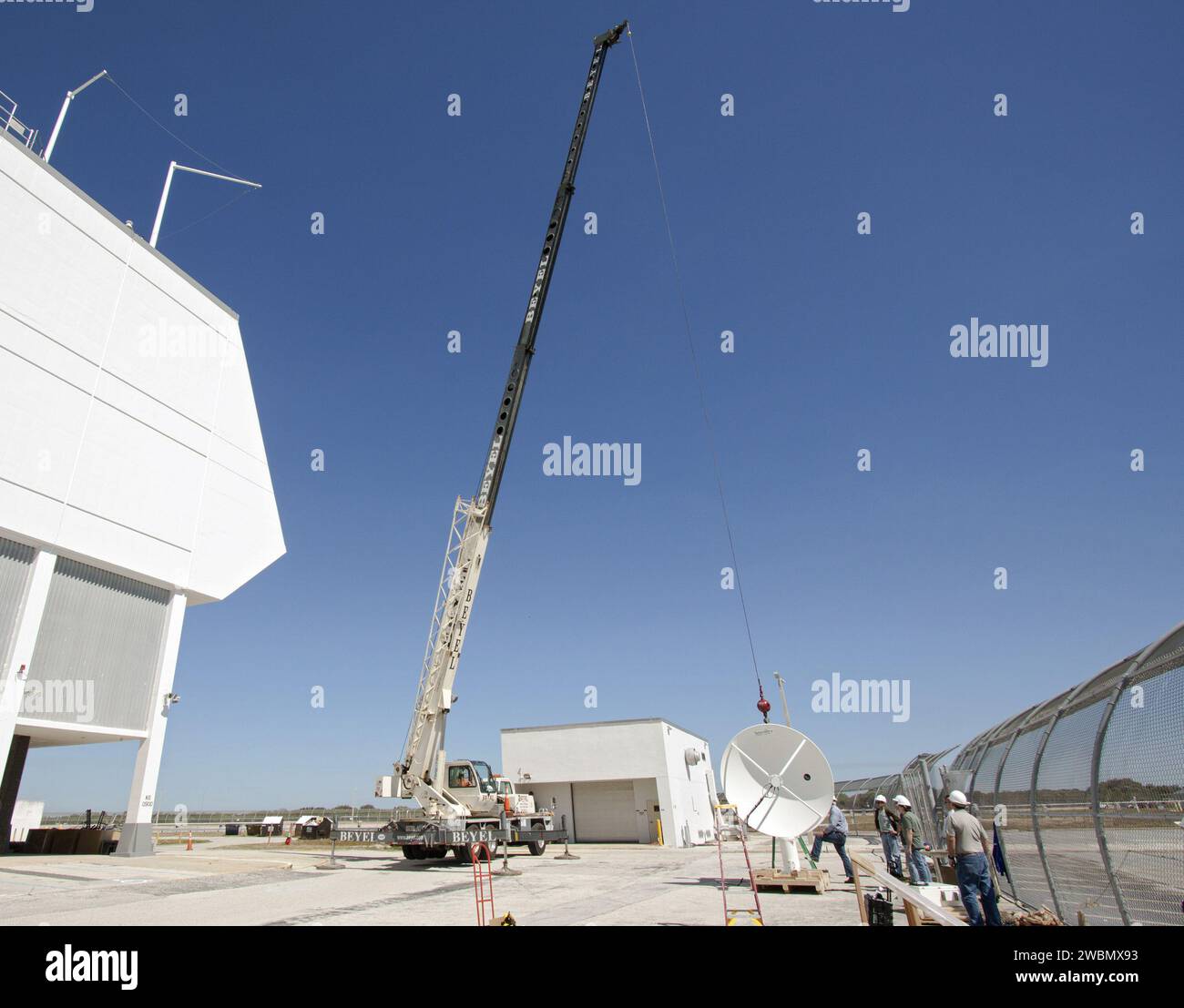 CAPE CANAVERAL, Fla. Workers use a crane to install a new parabolic