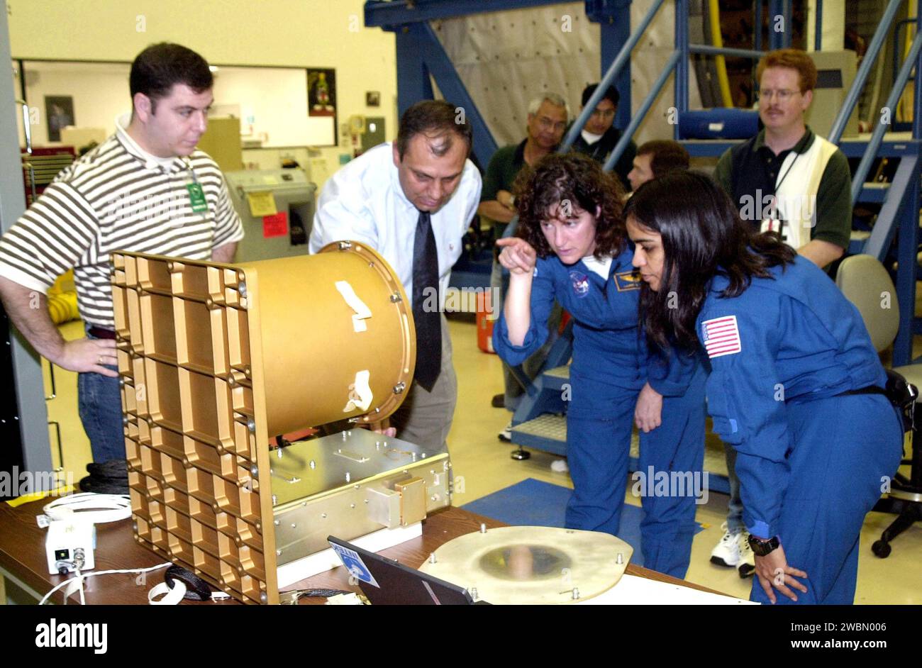 KENNEDY SPACE CENTER, FLA. - At SPACEHAB, Cape Canaveral, Fla., members of the STS-107 crew familiarize themselves with experiments and equipment for the mission. Pointing at a piece of equipment (center) is Mission Specialist Laurel Clark . At right is Mission Specialist Kalpana Chawla. STS-107 is a research mission. The primary payload is the first flight of the SHI Research Double Module (SHI RDM). The experiments range from material sciences to life sciences (many rats). Also part of the payload is the Fast Reaction Experiments Enabling Science, Technology, Applications and Research (FREES Stock Photo