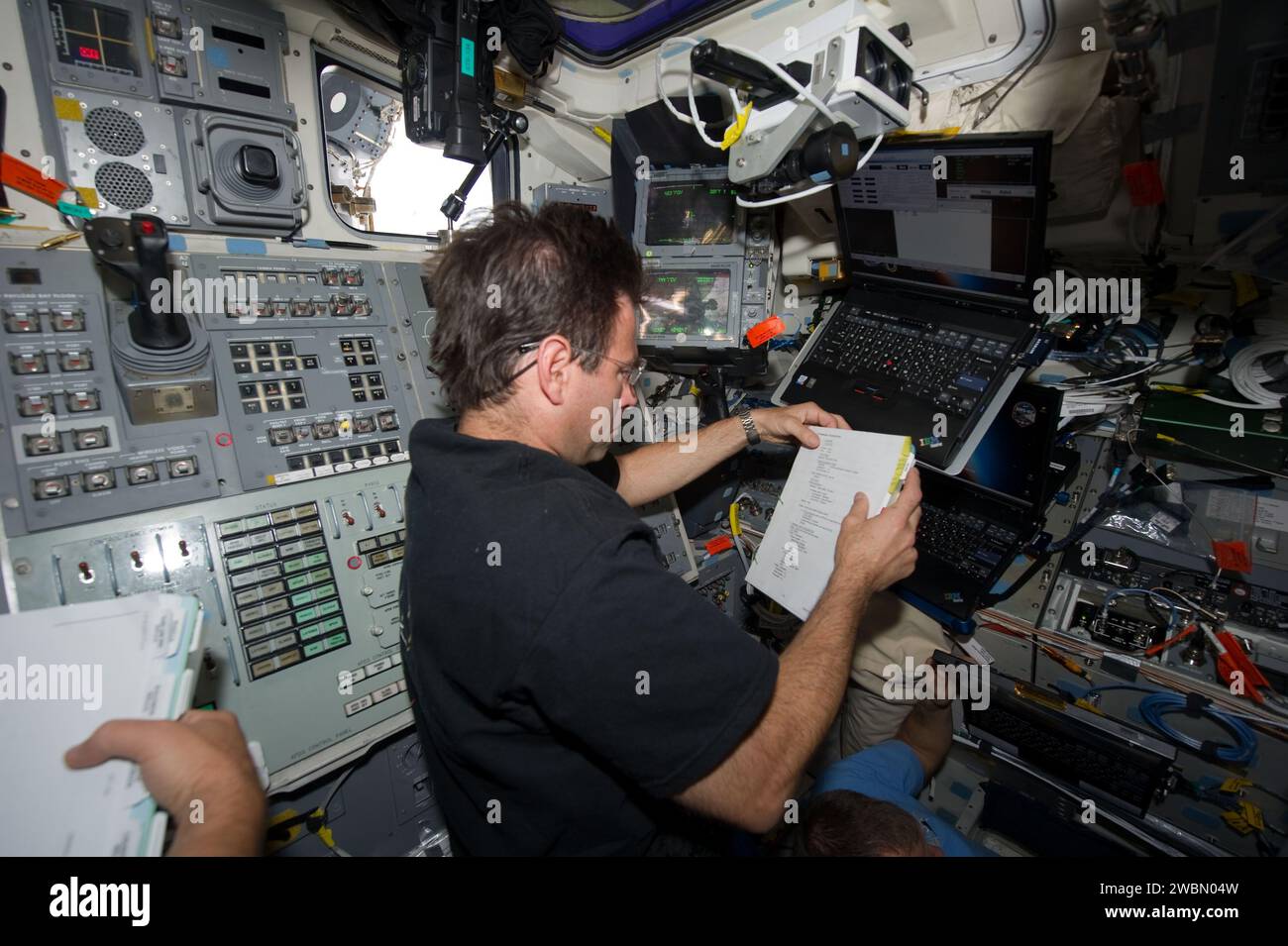 NASA astronaut Greg Chamitoff, STS-134 mission specialist, reads a ...