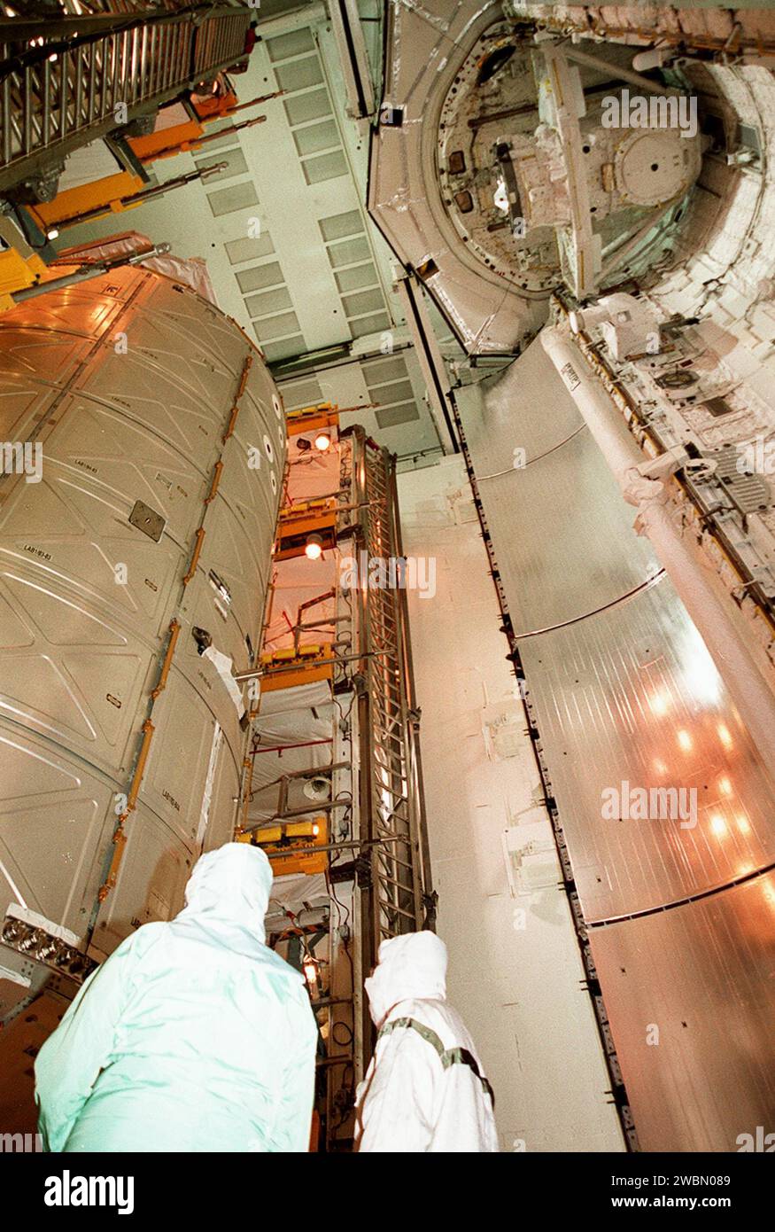 The U.S. Lab Destiny (left) moves away from Atlantis’ payload bay doors (right) into the Payload Changeout Room. Destiny will remain in the PCR while Atlantis rolls back to the Vehicle Assembly Building to allow workers to conduct inspections, continuity checks and X-ray analysis on the 36 solid rocket booster cables located inside each booster’s system tunnel. An extensive evaluation of NASA’s SRB cable inventory revealed conductor damage in four (of about 200) cables on the shelf. Shuttle managers decided to prove the integrity of the system tunnel cables already on Atlantis Stock Photo