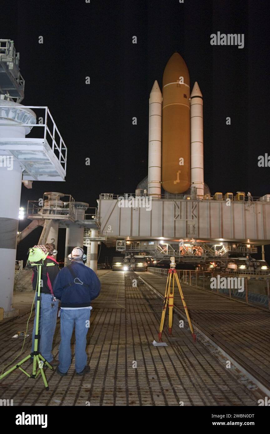 CAPE CANAVERAL, Fla. -- Workers monitor space shuttle Discovery as it arrives at Launch Pad 39A from the Vehicle Assembly Building at NASA's Kennedy Space Center in Florida. It took the shuttle, attached to its external fuel tank, twin solid rocket boosters and mobile launcher platform, about seven hours to complete the move atop a crawler-transporter. This is the second time Discovery has rolled out to the pad for the STS-133 mission, and comes after a thorough check and modifications to the shuttle's external tank.       Targeted to liftoff Feb. 24, Discovery will take the Permanent Multipur Stock Photo
