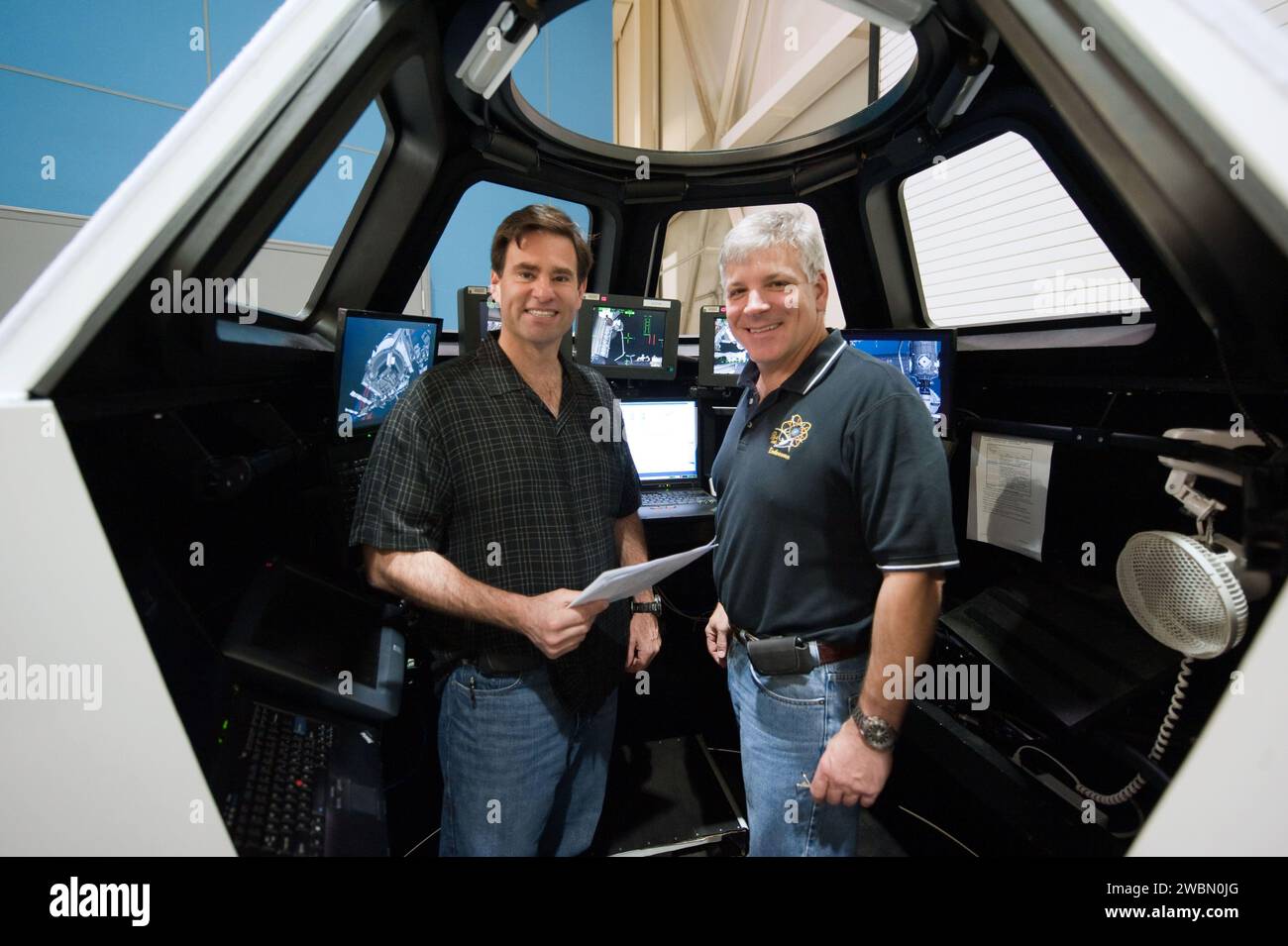 JSC2011-E-028160 (23 March 2011) --- NASA astronauts Greg H. Johnson (right), STS-134 pilot; and Greg Chamitoff, mission specialist, are pictured during an exercise in the systems engineering simulator in the Avionics Systems Laboratory at NASA's Johnson Space Center. Stock Photo