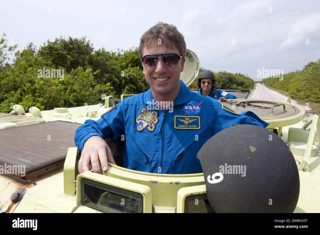 CAPE CANAVERAL, Fla. - Astronaut and Mission Specialist Roberto Vittori with the European Space Agency takes time out from driving practice of the M113 armored personnel carrier to pose for a photo at NASA's Kennedy Space Center in Florida. An M113 is kept at the foot of the launch pad in case an emergency exit from the pad is needed and every shuttle crew is trained on driving the vehicle before launch.        Space shuttle Endeavour's six crew members are at Kennedy for the launch countdown dress rehearsal called the Terminal Countdown Demonstration Test (TCDT) and related training. Targeted Stock Photo