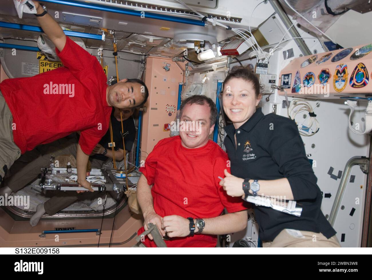 S132-E-009158  (22 May 2010) --- Two thirds of the Expedition 23 crew, which is hosting six Atlantis STS-132 astronauts for approximately a week of shared work on the International Space Station, will be joining two crewmates out of frame in saying farewell to the shuttle crew tomorrow,  May 23.  In the Unity node’s  foreground are, from left, Japan Aerospace Exploration Agency astronaut Soichi Noguchi, along with NASA astronauts T.J. Creamer and Tracy Caldwell Dyson, all flight engineers.  Russian cosmonaut Alexander Skvortsov, Expedition 23 flight engineer, can be seen, partially obscured, i Stock Photo