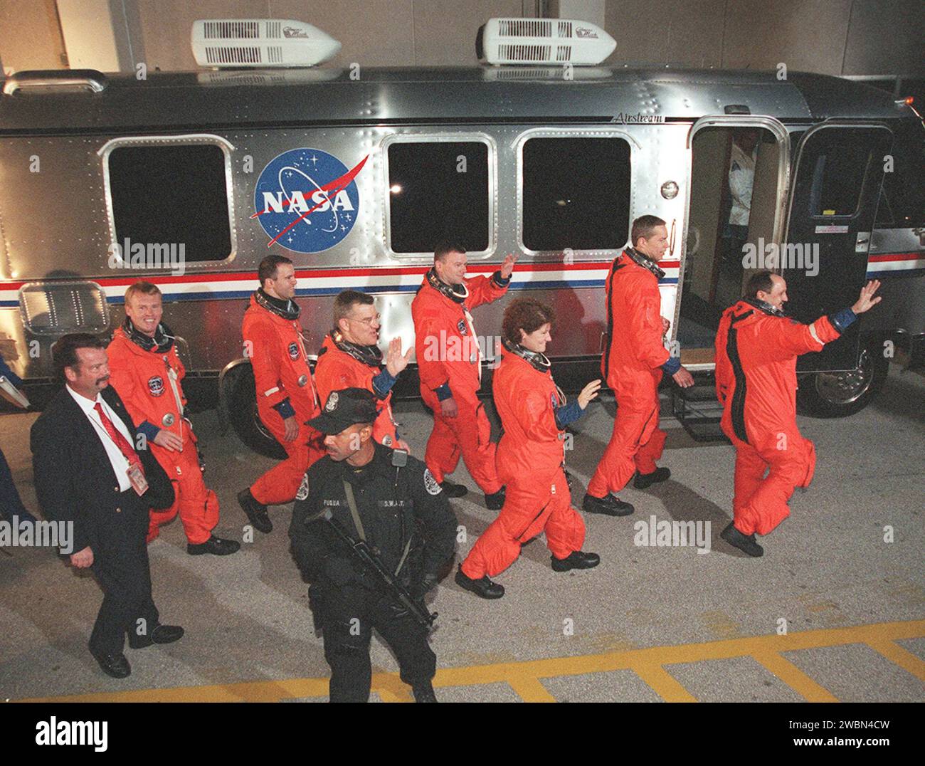 The STS-102 crew wave to onlookers as they head for the Astrovan after leaving the Operations and Checkout Building. Left to right are Mission Specialists Andrew Thomas, Paul Richards and James Voss; Pilot James Kelly; Mission Specialist Susan Helms; Commander James Wetherbee; and Mission Specialist Yury Usachev. STS-102 is the eighth construction flight to the Space Station, carrying the Multi-Purpose Logistics Module Leonardo. The primary delivery system used to resupply and return Station cargo requiring a pressurized environment, Leonardo will deliver up to 10 tons of laboratory racks fill Stock Photo