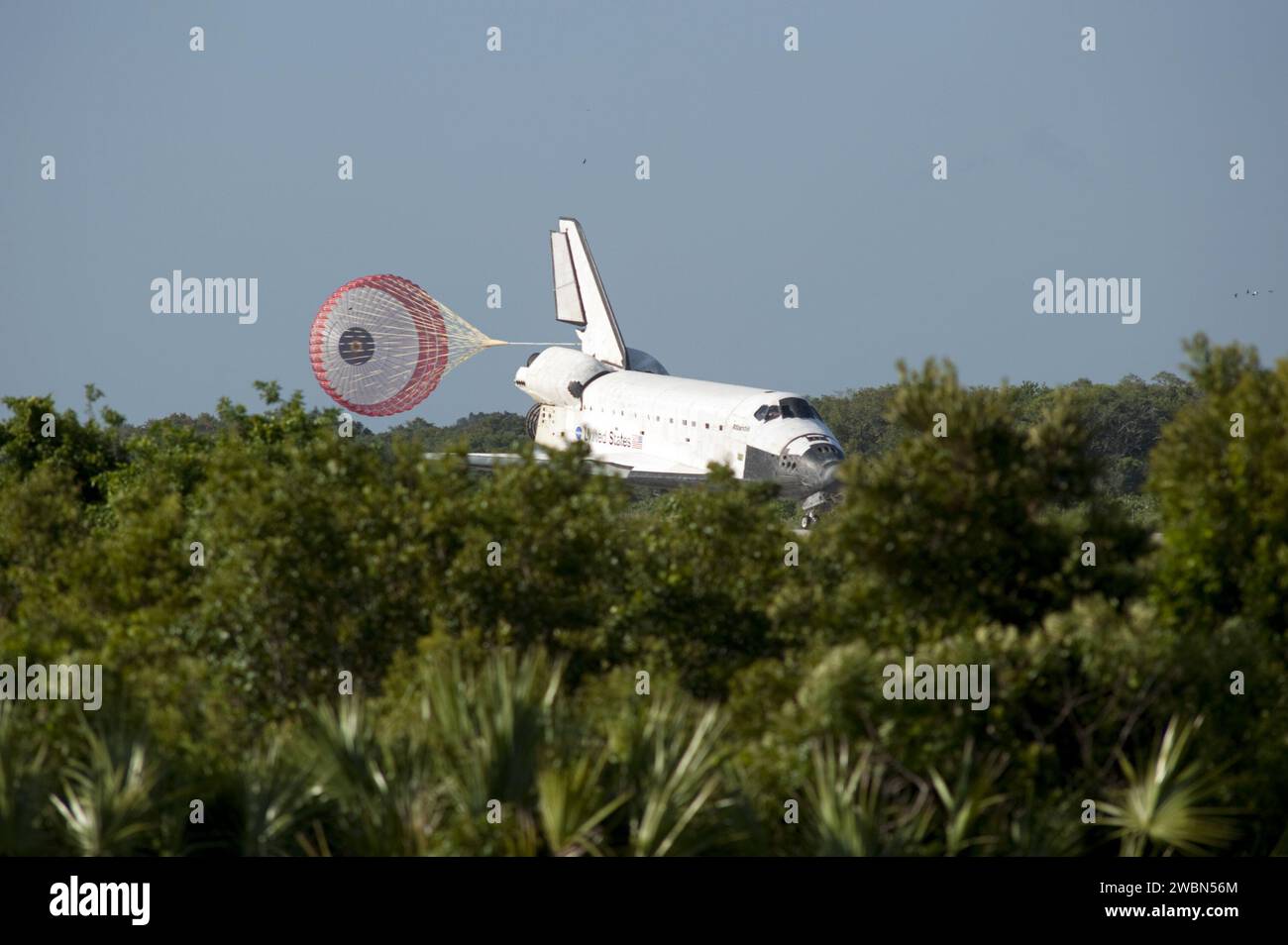 Space Shuttle Atlantis uses its drag chute to decelerate on Runway 33 ...