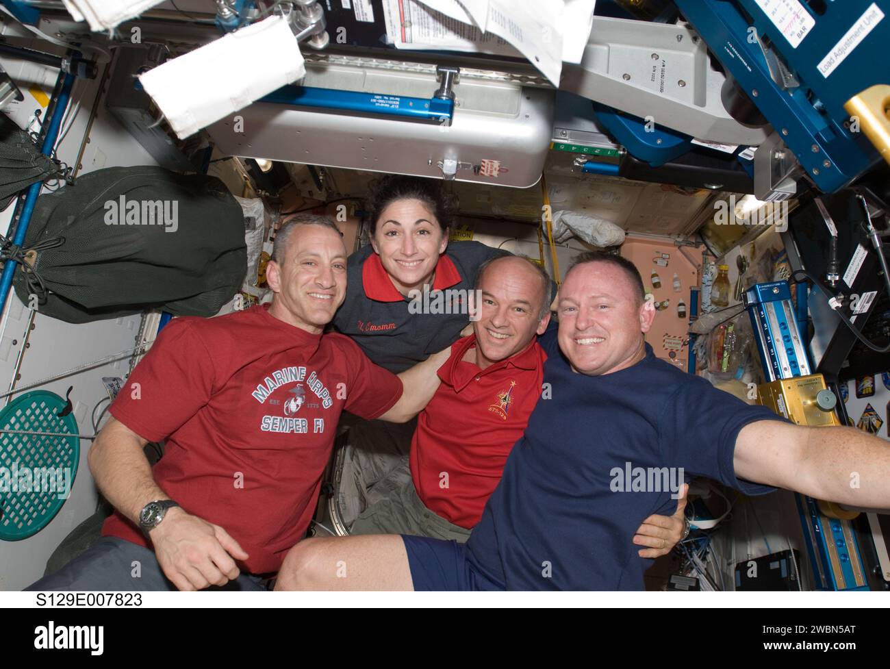 S129-E-007823 (22 Nov. 2009) --- Astronauts Charles O. Hobaugh (left), STS-129 commander; Nicole Stott, mission specialist; Jeffrey Williams, Expedition 21 flight engineer; and Barry E. Wilmore, STS-129 pilot, pose for a photo in the Unity node of the International Space Station while space shuttle Atlantis remains docked with the station. Stock Photo