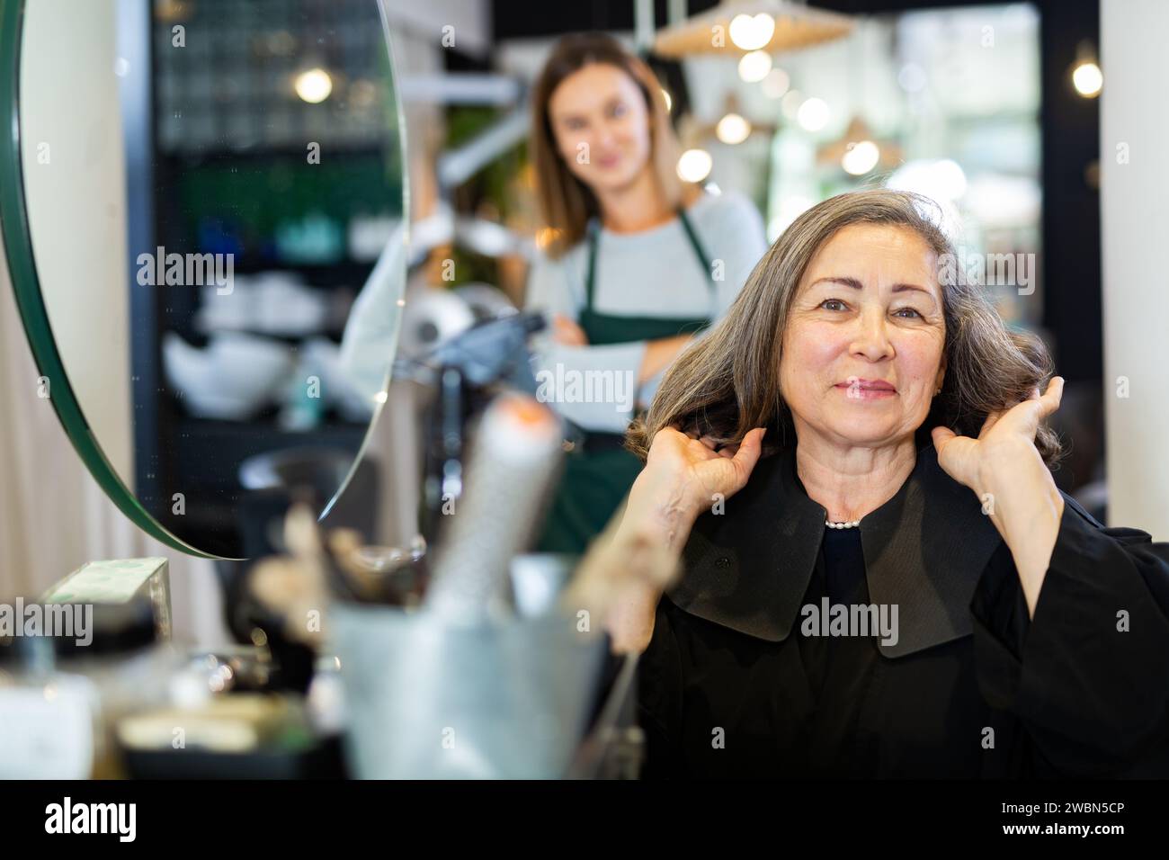 Female hair stylist finishing hi-res stock photography and images - Alamy