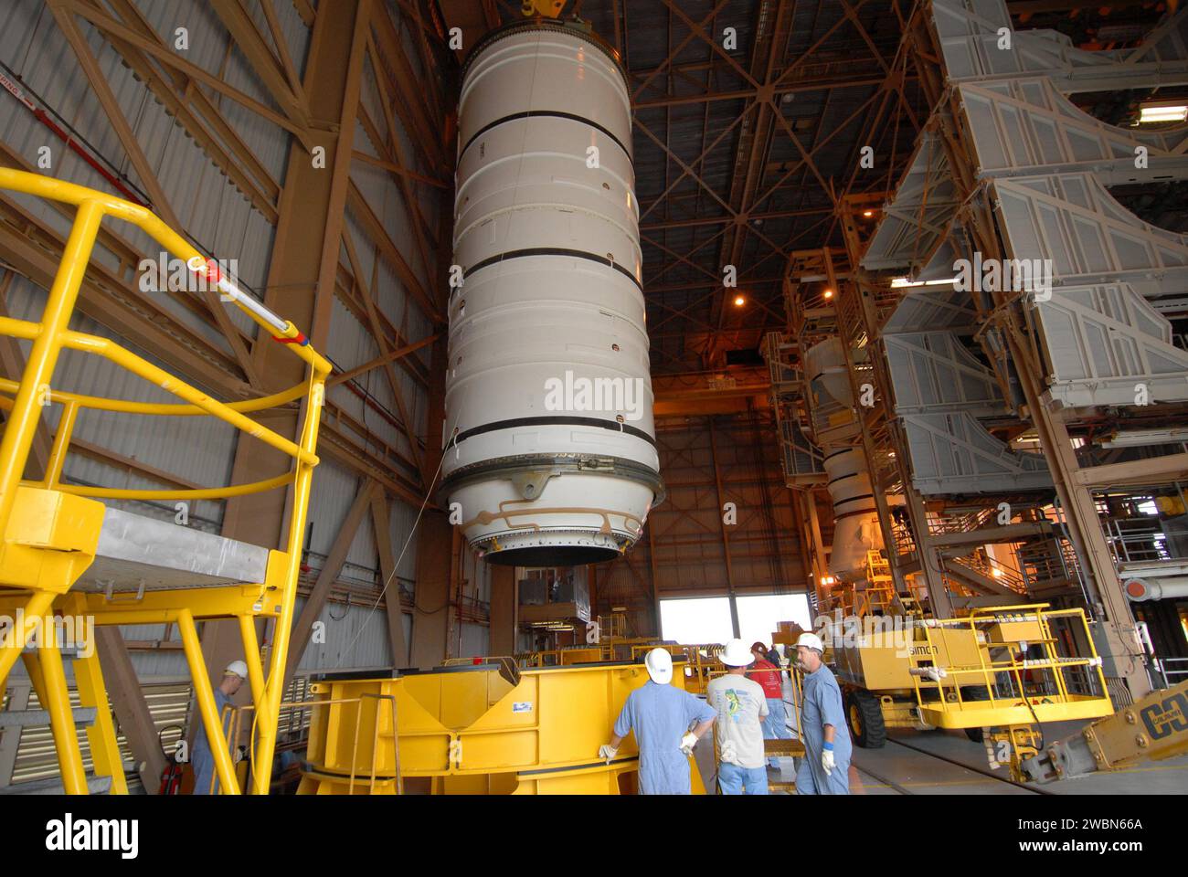CAPE CANAVERAL, Fla. –  Technicians stand by as the Ares I-X motor segment is moved toward a work stand in the Rotation, Processing and Surge Facility at NASA's Kennedy Space Center in Florida. Four segments were delivered to Kennedy for final processing and integration. The booster used for the Ares I-X launch is being modified by adding new forward structures and a fifth segment simulator. The motor is the final hardware needed for the rocket's upcoming test flight this summer. The stacking operations are scheduled to begin in the Vehicle Assembly Building in April. Stock Photo
