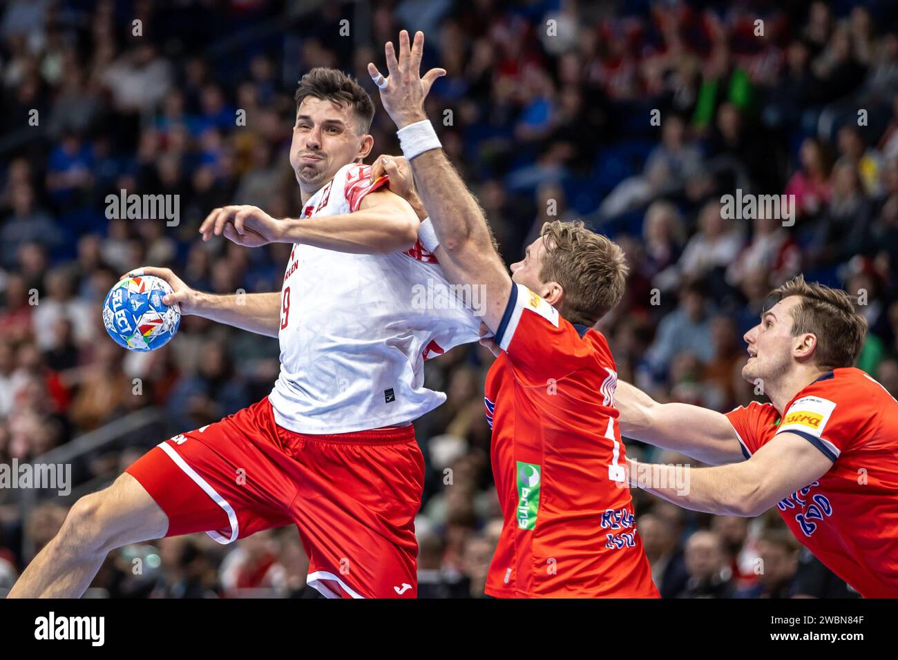 Berlin, Germany. 11th Jan, 2024. Handball: European Championship, Norway - Poland, preliminary round, Group D, match day 1, Mercedes-Benz Arena. Poland's Szymon Sicko (l) throws the ball on goal against Norway's Petter Overby. Credit: Andreas Gora/dpa/Alamy Live News Stock Photo