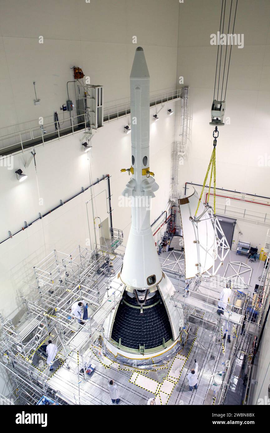 The last major assembly operation to prepare Orion for Exploration Flight Test-1 (EFT-1) is completed in the Launch Abort System Facility (LASF) at Kennedy Space Center on Oct. 11, 2014. The ogive panels, which protect the crew module from sound and vibration during ascent, were installed around the spacecraft just below the launch abort system tower.    Part of Batch image transfer from Flickr. Stock Photo