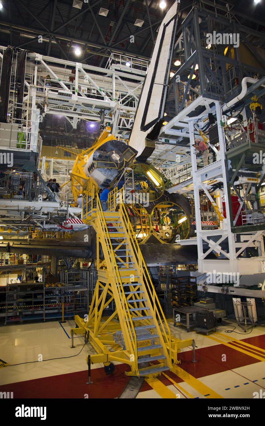 Crane Pod Example Technicians guide a crane lowering an OMS pod for installation on space ...