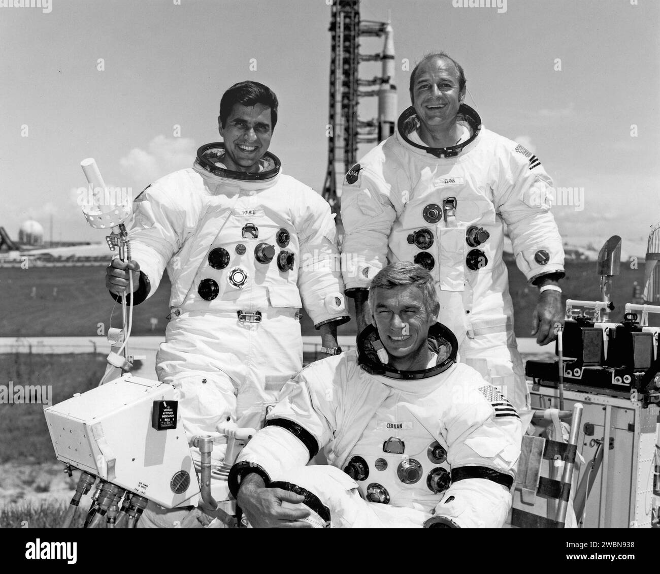 CAPE CANAVERAL, Fla. -- The Apollo 17 crew took time out from training to pose for the press after the Space Vehicle for their Manned Lunar Landing Mission was moved to Pad A, Complex 39 today. Apollo 17 Commander Eugene A Cernan sits at the controls of the One-G Lunar Roving Vehicle Simulator used to simulate operations on the Moon’s surface. With Cernan are Lunar Module Pilot Dr. Harrison H. “Jack” Schmitt, left and Command Module Plot Ronald A. Evans. The Apollo 17 Space Vehicle, scheduled for launch from KSC on the sixth U.S. Manned Lunar Landing Mission on December 6, 1972 is in the backg Stock Photo