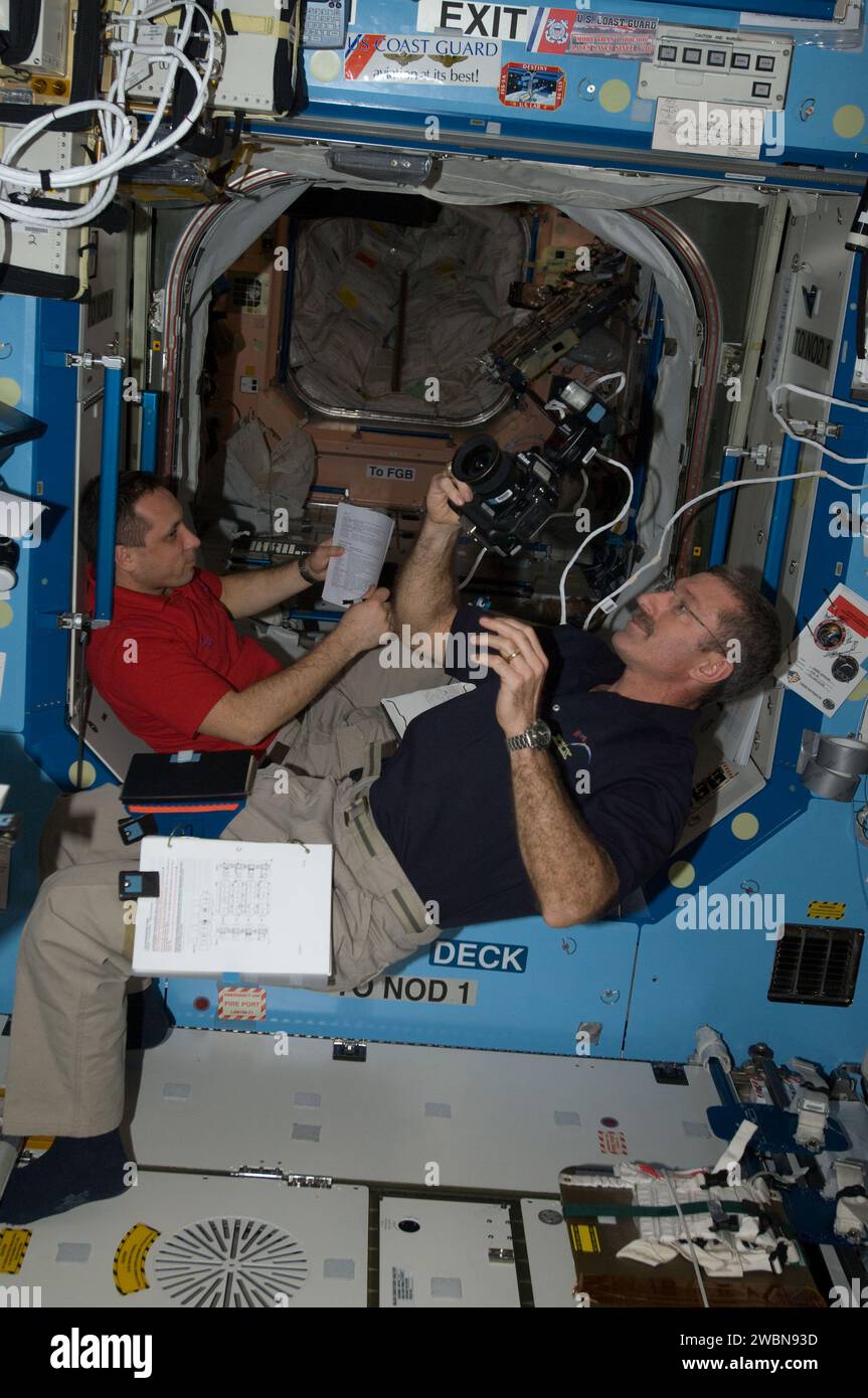NASA astronaut Dan Burbank photographs while cosmonaut Anton Shkaplerov ...
