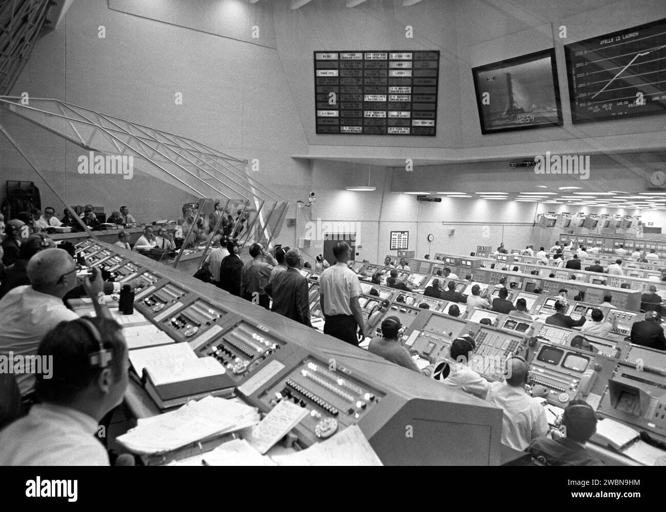 CAPE CANAVERAL, Fla. -- Personnel within Firing Room 2 of the LCC follow the early moments of the Apollo 12 launch on their overhead data display boards. When this view was taken, the vehicle’s second stage engines had ignited, carrying the Apollo 12 spacecraft to an altitude of more than 229,000 feet and more that 50 miles downrange. Stock Photo