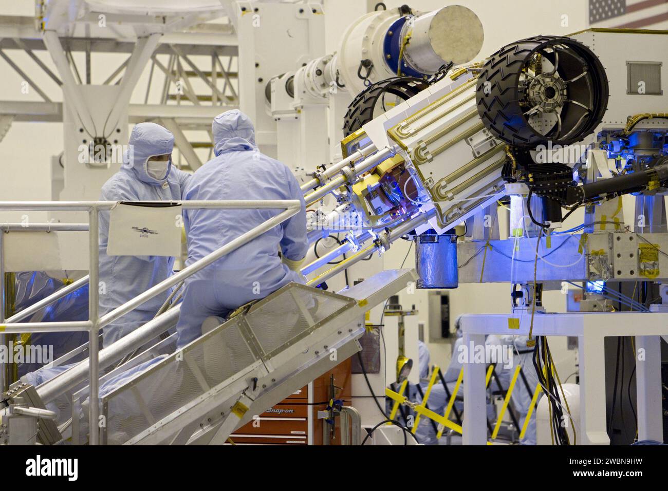JPL technicians use extension tools to attach the MMRTG onto Curiosity ...