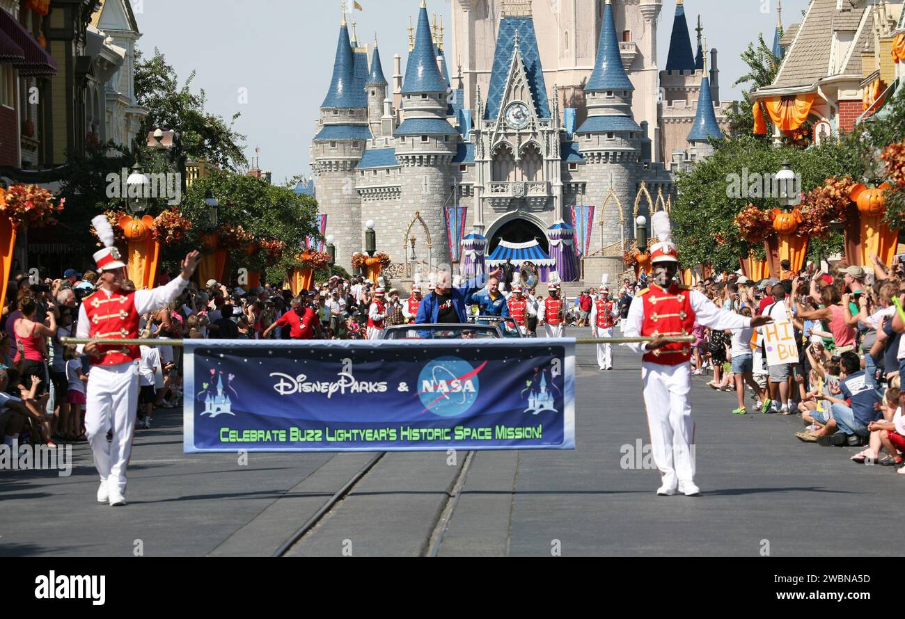 CAPE CANAVERAL, Fla. – At Walt Disney World's Magic Kingdom in Orlando, Fla., a ticker-tape parade officially welcomes toy space ranger Buzz Lightyear home from space.  NASA Apollo 11 astronaut Buzz Aldrin, behind the banner, and International Space Station commander Mike Fincke are featured in the procession.  The 12-inch-tall action figure spent more than 15 months aboard the International Space Station and returned to Earth aboard space shuttle Discovery on Sept. 11 with the STS-128 crew.  Lightyear's space adventure, a collaboration between NASA and Disney Parks, is intended to share the e Stock Photo