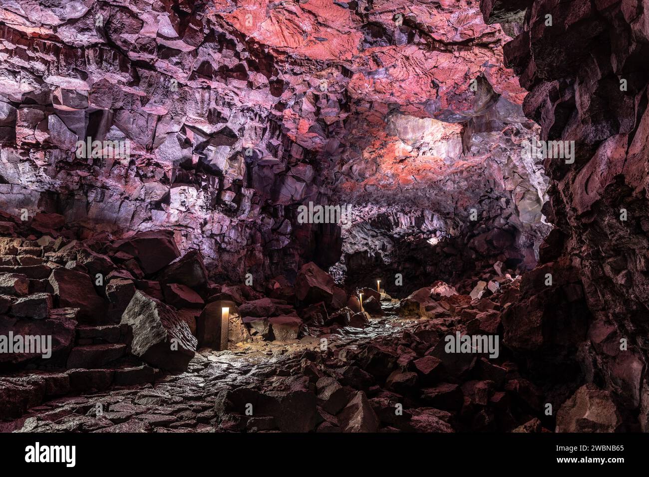 Purple illuminated rock structures of the underworld Stock Photo Alamy