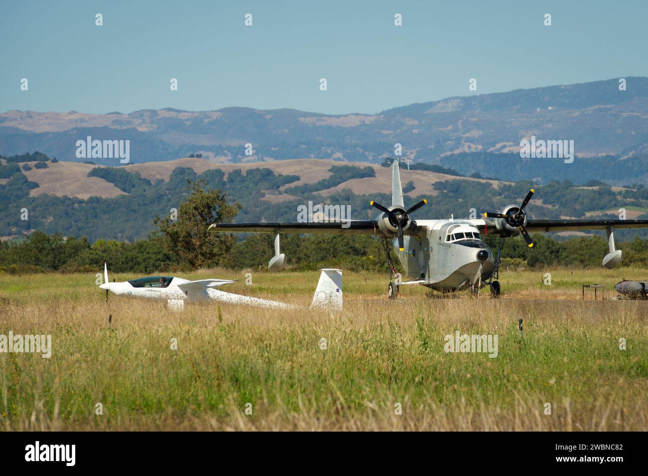 The Embry-Riddle Aeronautical University, EcoEagle is seen as it passes a Grumman Albatross during the 2011 Green Flight Challenge, sponsored by Google, at the Charles M. Schulz Sonoma County Airport in Santa Rosa, Calif. on Monday, Sept. 26, 2011.  NASA and the Comparative Aircraft Flight Efficiency (CAFE) Foundation are having the challenge with the goal to advance technologies in fuel efficiency and reduced emissions with cleaner renewable fuels and electric aircraft. Stock Photo