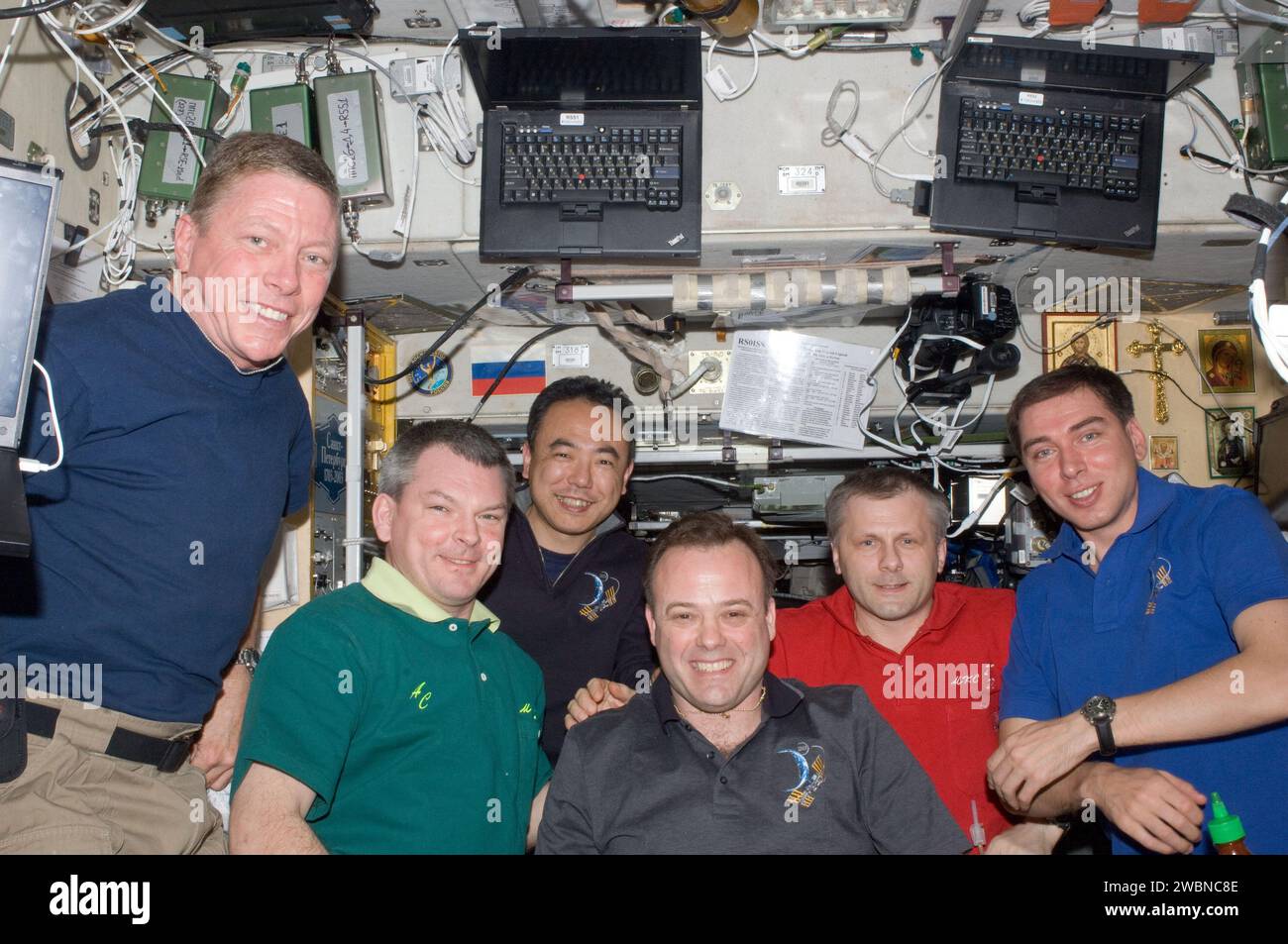 ISS028-E-009701 (25 June 2011) --- Expedition 28 crew members pose for a photo in the Zvezda Service Module of the International Space Station. Pictured from the left are NASA astronaut Mike Fossum, Russian cosmonaut Alexander Samokutyaev, Japan Aerospace Exploration Agency astronaut Satoshi Furukawa, NASA astronaut Ron Garan, all flight engineers; Russian cosmonaut Andrey Borisenko, commander; and Russian cosmonaut Sergei Volkov, flight engineer. Stock Photo