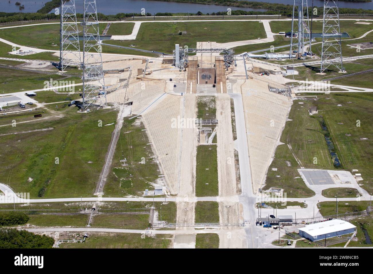 CAPE CANAVERAL, Fla. – An aerial view shows construction progress at Launch Pad 39B at NASA’s Kennedy Space Center in Florida. A new elevator has been constructed on the surface of the pad and the crawlerway leading up to the surface is being repaired. Repairs also are being made to the crawler track panels and catacomb roof below on either side of the flame trench. Also in view are portions of the water tower and the three tall lightning towers that surround the pad. Upgrades are underway at Pad B and other facilities in the Launch Complex 39 area. The Ground Systems Development and Operation Stock Photo