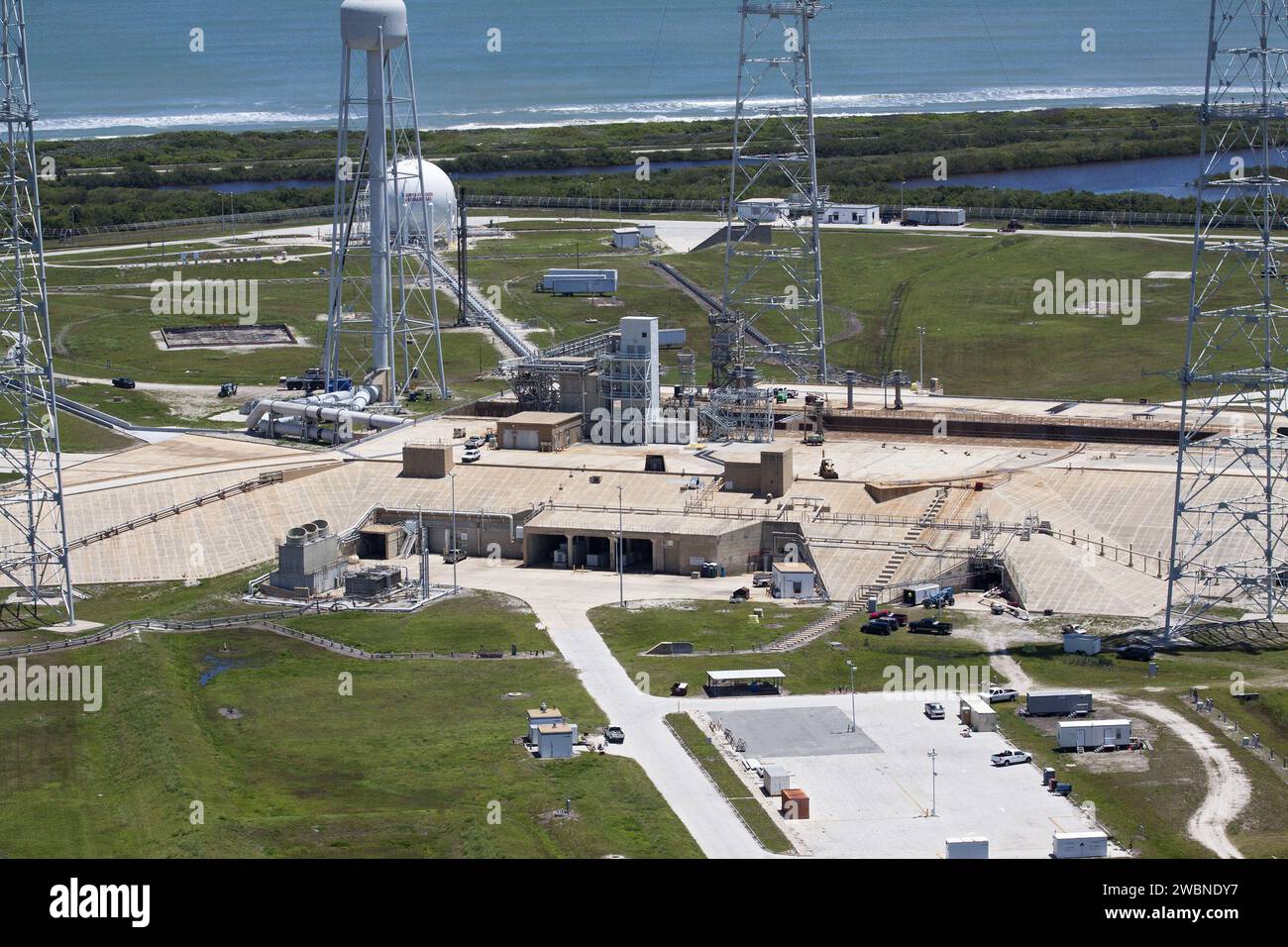 CAPE CANAVERAL, Fla. – An aerial view shows construction progress at Launch Pad 39B at NASA’s Kennedy Space Center in Florida. A new elevator has been constructed on the surface of the pad and the crawlerway leading up to the surface is being repaired. Repairs also are being made to the crawler track panels and catacomb roof below on either side of the flame trench. Also in view are the water tower and the three tall lightning towers that surround the pad. Upgrades are underway at Pad B and other facilities in the Launch Complex 39 area. The Ground Systems Development and Operations, or GSDO, Stock Photo
