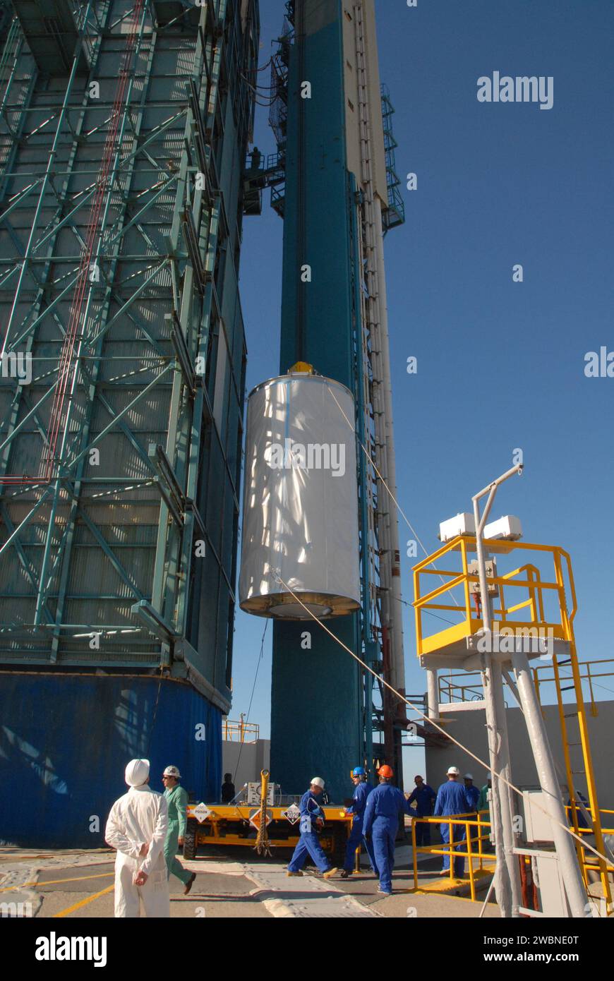 Workers at Vandenberg Air Force Base's Space Launch Complex-2 prepare to hoist NASA’s National Polar-orbiting Operational Environmental Satellite System Preparatory Project (NPP) spacecraft, which is tucked inside a protective payload transportation canister. NPP represents a critical first step in building the next-generation of Earth-observing satellites. NPP will carry the first of the new sensors developed for this satellite fleet, now known as the Joint Polar Satellite System (JPSS), to be launched in 2016. NPP is the bridge between NASA's Earth Observing System (EOS) satellites and the f Stock Photo