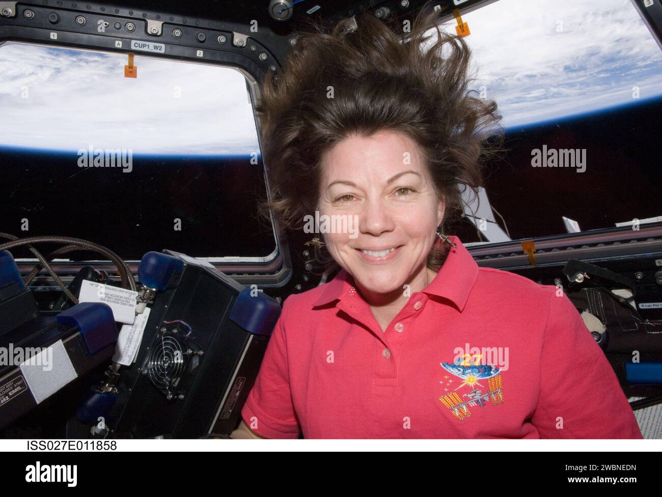 ISS027-E-011858 (7 April 2011) --- NASA astronaut Cady Coleman, Expedition 27 flight engineer, is pictured in the Cupola of the International Space Station. Earth’s horizon and the blackness of space are visible through the windows. Stock Photo