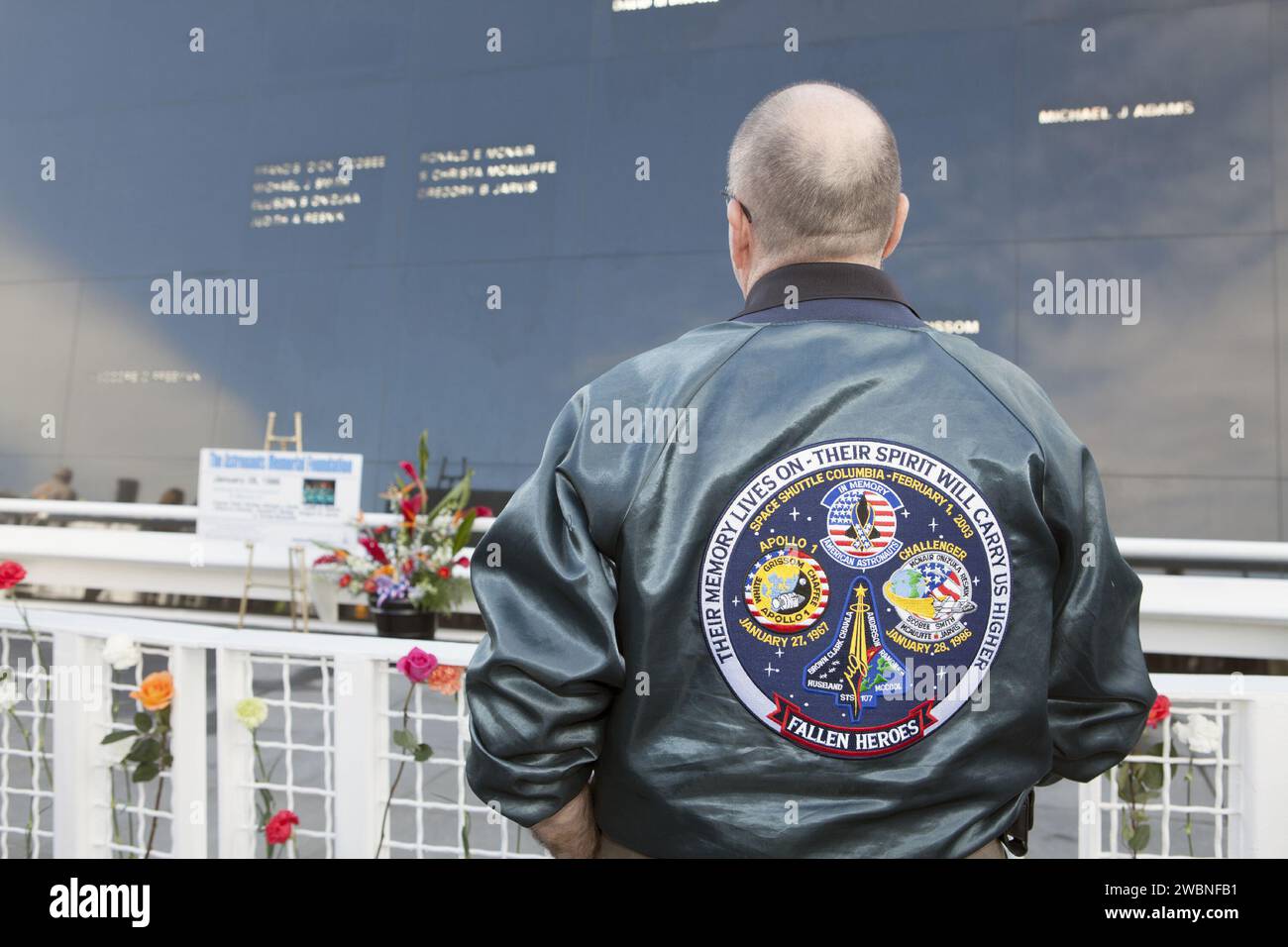 CAPE CANAVERAL, Fla. – The emblem on the jacket of a guest at NASA's Kennedy Space Center Visitor Complex commemorates NASA's 'fallen heroes' whose names are etched on the Astronauts Memorial Foundation's Space Mirror Memorial, following a ceremony on the 28th anniversary of the space shuttle Challenger accident. The day of the accident in 1986 dawned bitterly cold. Temperatures hovered just a few degrees above freezing as Challenger and its seven astronauts lifted off on the STS-51L mission. The flight ended just 73 seconds later when an O-ring in the right solid rocket booster failed, causin Stock Photo