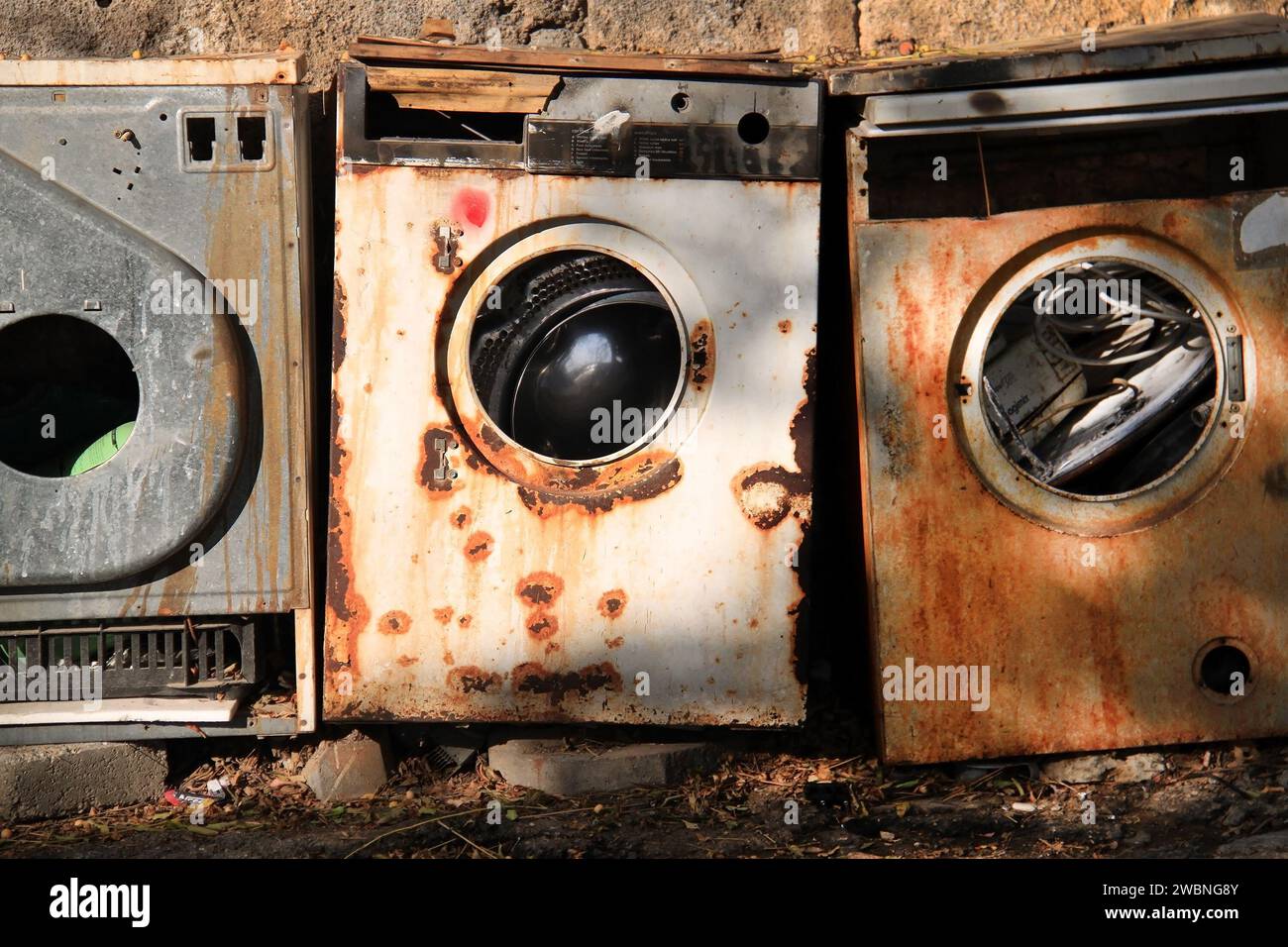 Abandoned rusty washing machines in nature. Stock Photo
