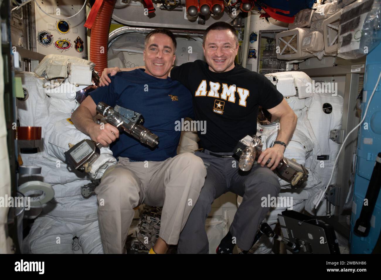 iss062e147776 (April 12, 2020) --- NASA astronauts (from left) Chris Cassidy and Andrew Morgan take a break and pose for a portrait inside the Quest airlock during maintenance on U.S. spacesuits. Cassidy is a U.S. Navy SEAL and Captain. Morgan is an emergency physician and Colonel in the U.S. Army. Stock Photo