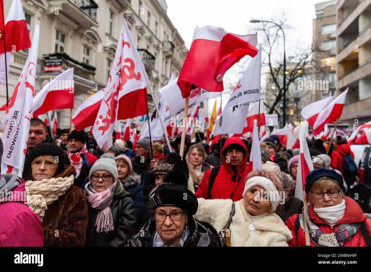 Warsaw, Poland, 11th of January 2024. Crowds of people, holding Polish