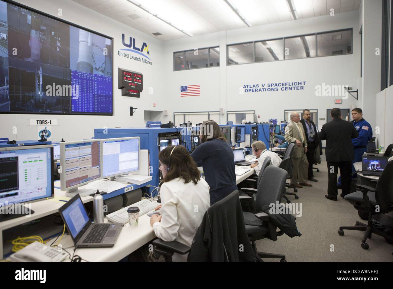 NASA and contractor engineers monitor the countdown for TDRS-L launch atop Atlas V at Cape Canaveral Spaceflight Operations Center. TDRS-L is the second of three satellites in the TDRSS fleet providing tracking, telemetry, command, and data services for NASA missions including Hubble and ISS. Stock Photo