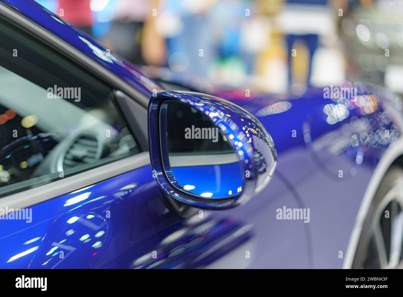 close-up shot showcasing the sleek blue side mirror of a modern car reflective surface and streamlined design exude contemporary style, embodying the Stock Photo