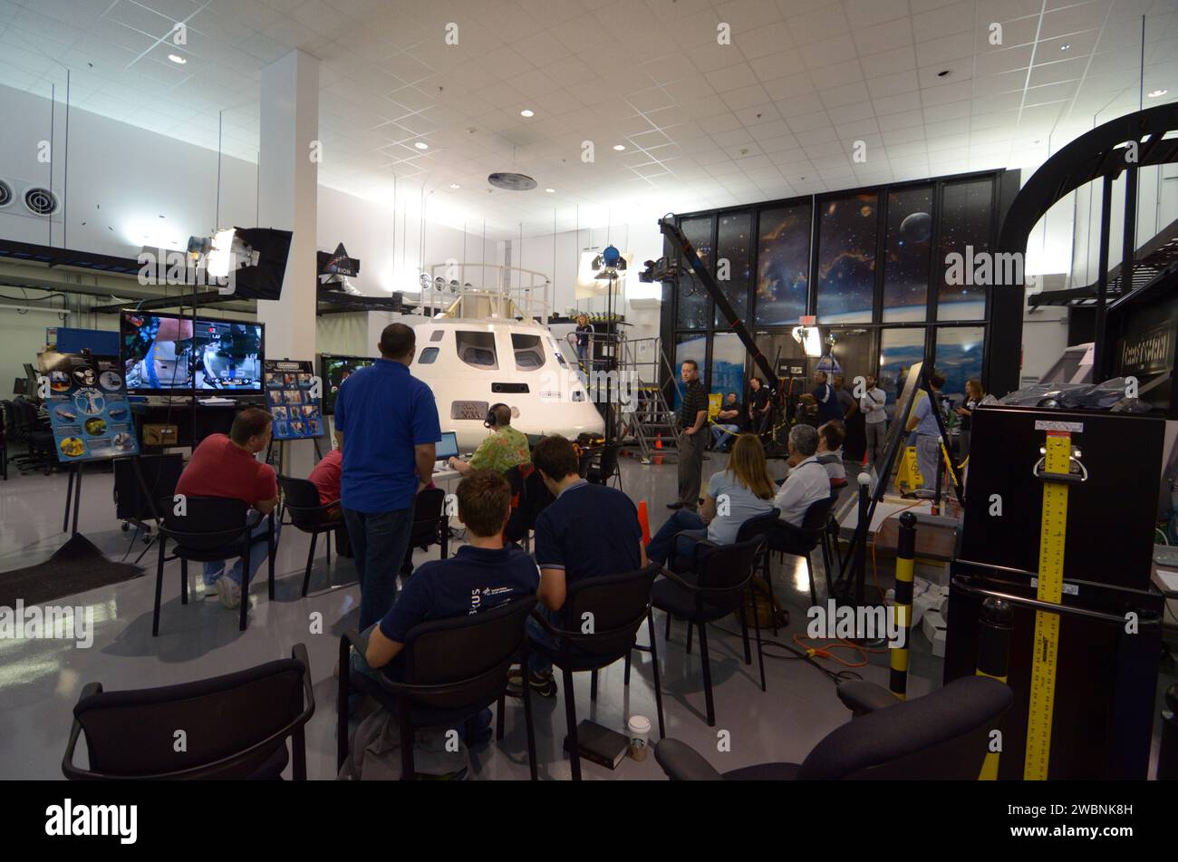 Engineers evaluate early space suit designs in an Orion mockup at ...