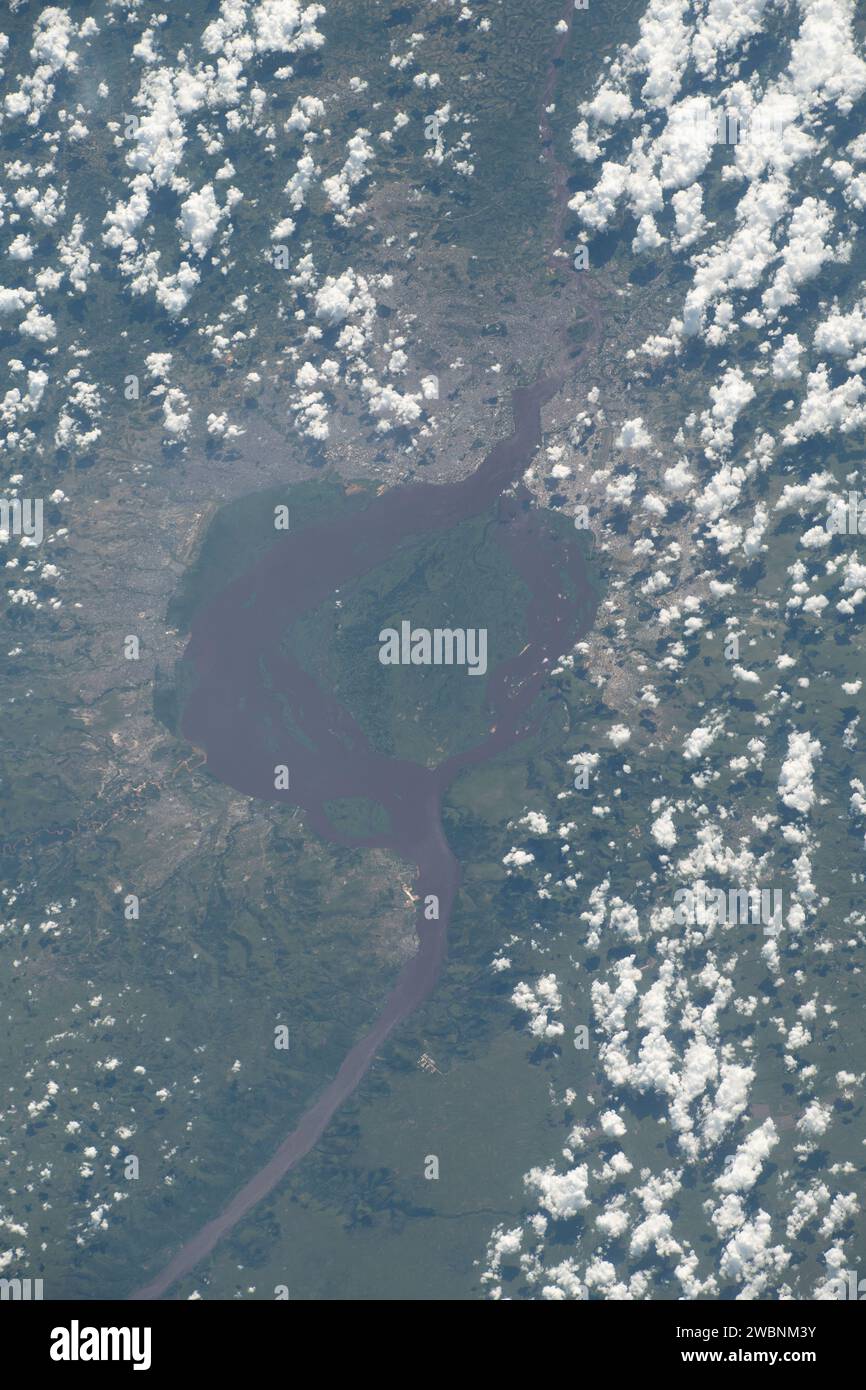 iss070e030605 (Nov. 20, 2023) --- The Congo River encircles the island of Mbamu and splits two cities, both capitals of their respective nations. At left, Kinshasa represents the Democratic Republic of Congo, and at right, Brazzaville represents the Republic of Congo in this photograph from the International Space Station as it orbited 260 miles above the African continent. Stock Photo