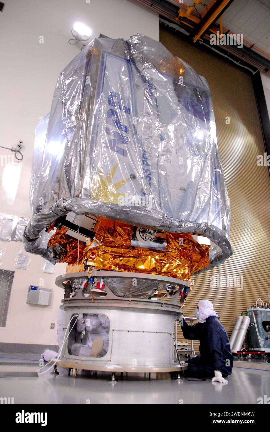 In a clean room inside the Astrotech Payload Processing Facility at Vandenberg Air Force Base in California, a Ball Aerospace technician NASA’s National Polar-orbiting Operational Environmental Satellite System Preparatory Project (NPP) spacecraft for its move to the launch pad. NPP represents a critical first step in building the next-generation of Earth-observing satellites. NPP will carry the first of the new sensors developed for this satellite fleet, now known as the Joint Polar Satellite System (JPSS), to be launched in 2016. NPP is the bridge between NASA's Earth Observing System (EOS) Stock Photo