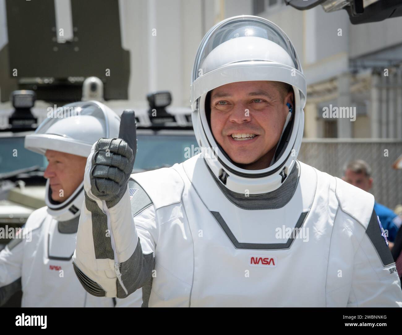 NASA astronauts Robert Behnken, foreground, and Douglas Hurley, wearing SpaceX spacesuits, are seen as they depart the Neil A. Armstrong Operations and Checkout Building for Launch Complex 39A to board the SpaceX Crew Dragon spacecraft for the Demo-2 mission launch, Saturday, May 30, 2020, at NASA’s Kennedy Space Center in Florida. NASA’s SpaceX Demo-2 mission is the first launch with astronauts of the SpaceX Crew Dragon spacecraft and Falcon 9 rocket to the International Space Station as part of the agency’s Commercial Crew Program. The test flight serves as an end-to-end demonstration of Spa Stock Photo