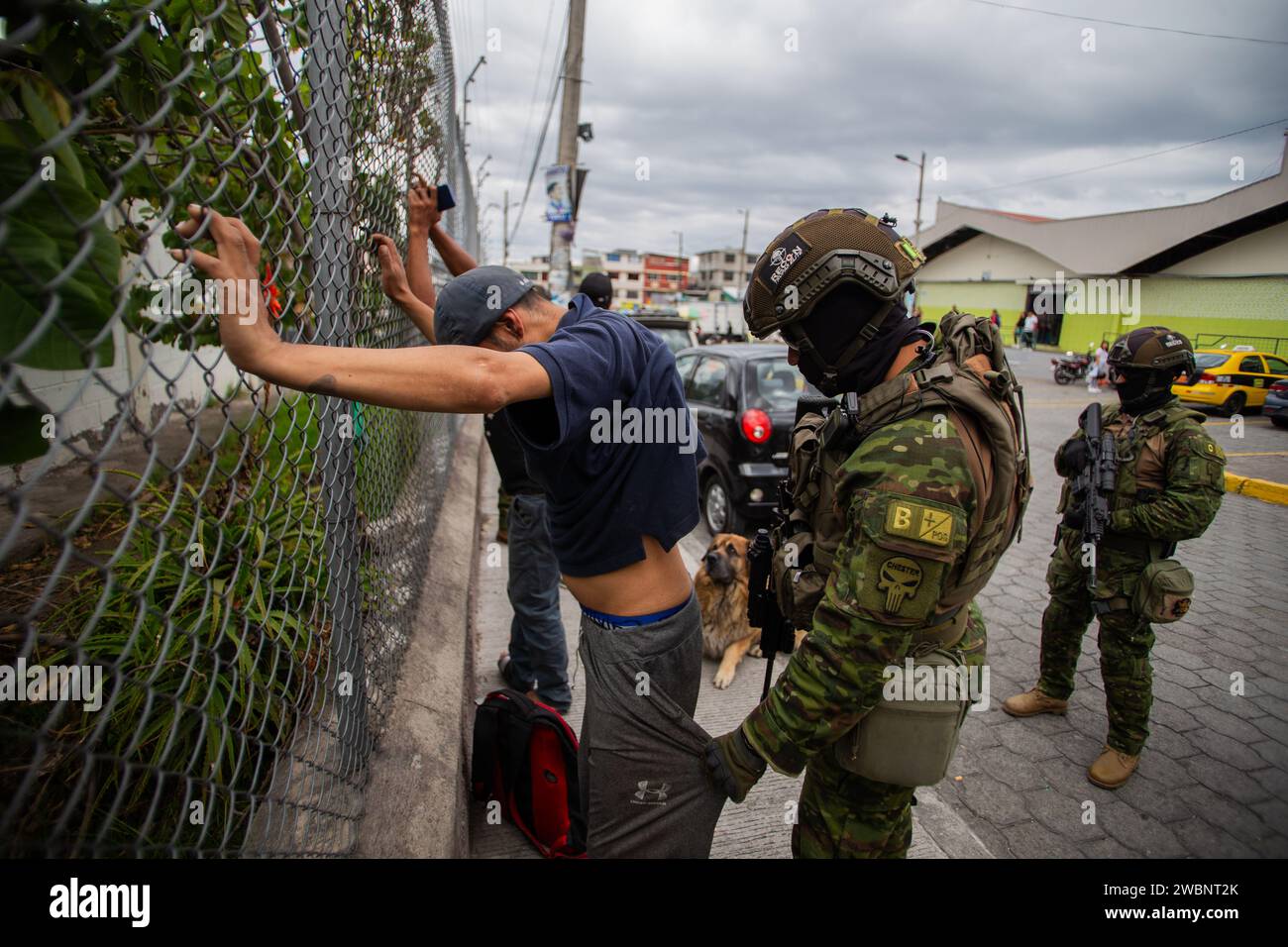 Quito, Ecuador. 11th Jan, 2024. A soldier searches a man in front of