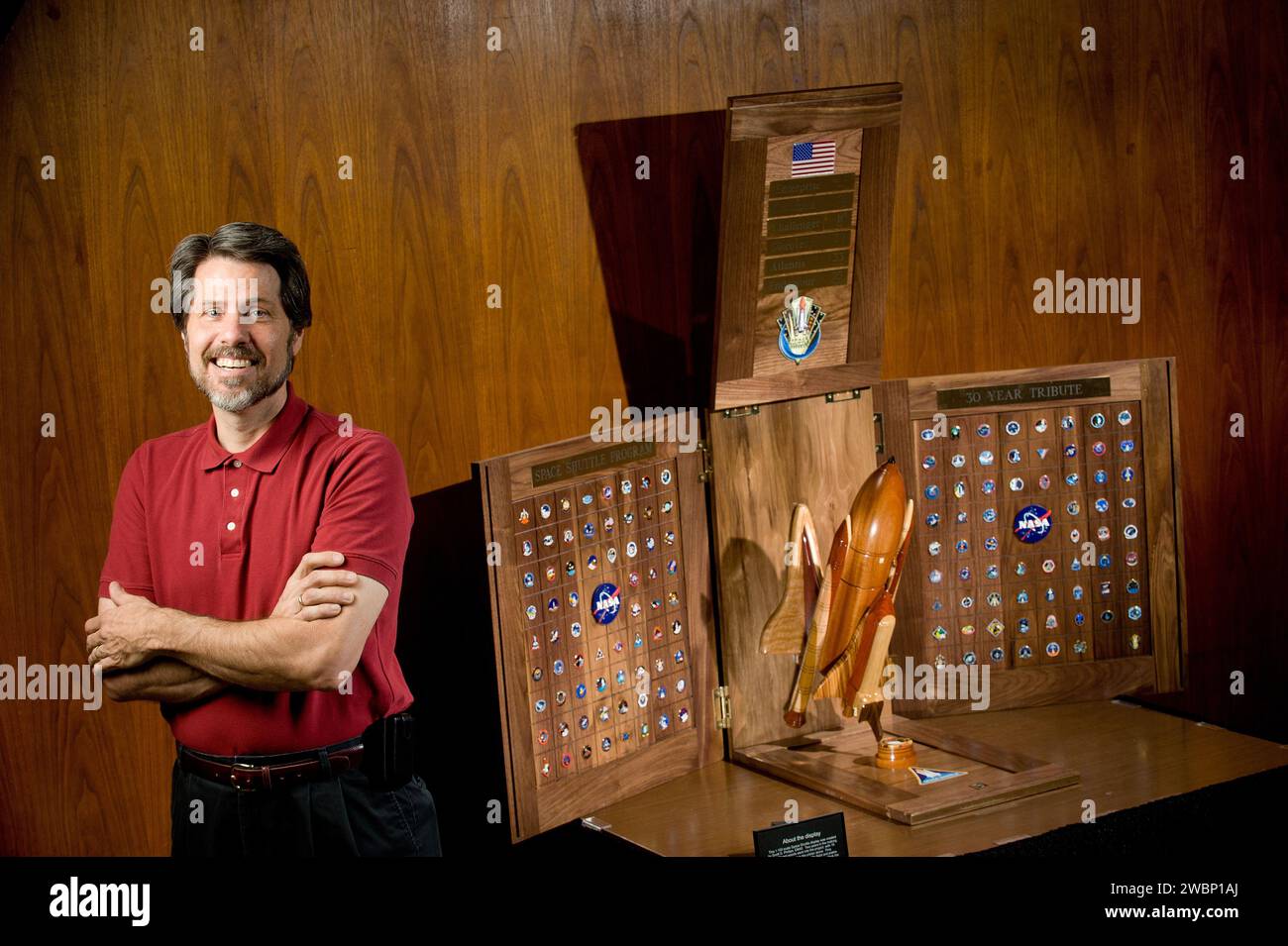 SCOTT PHILLIPS STANDS NEAR HIS LATEST WOODWORKING CREATION FEATURING A SHUTTLE MODEL AND ALL OF THE MISSION PINS FROM PREVIOUS LAUNCHES. Stock Photo