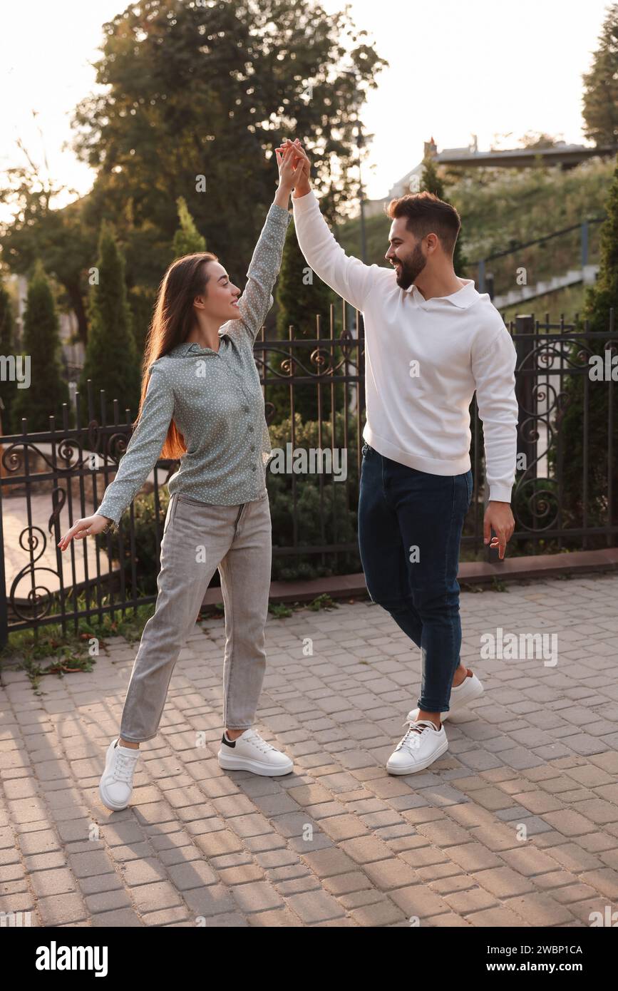 Lovely couple dancing together outdoors at sunset Stock Photo - Alamy
