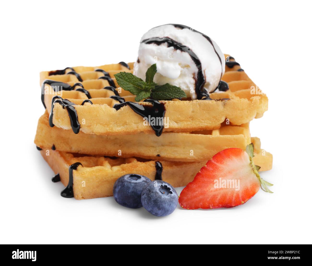 Tasty Belgian waffles with ice cream, berries and chocolate syrup on ...