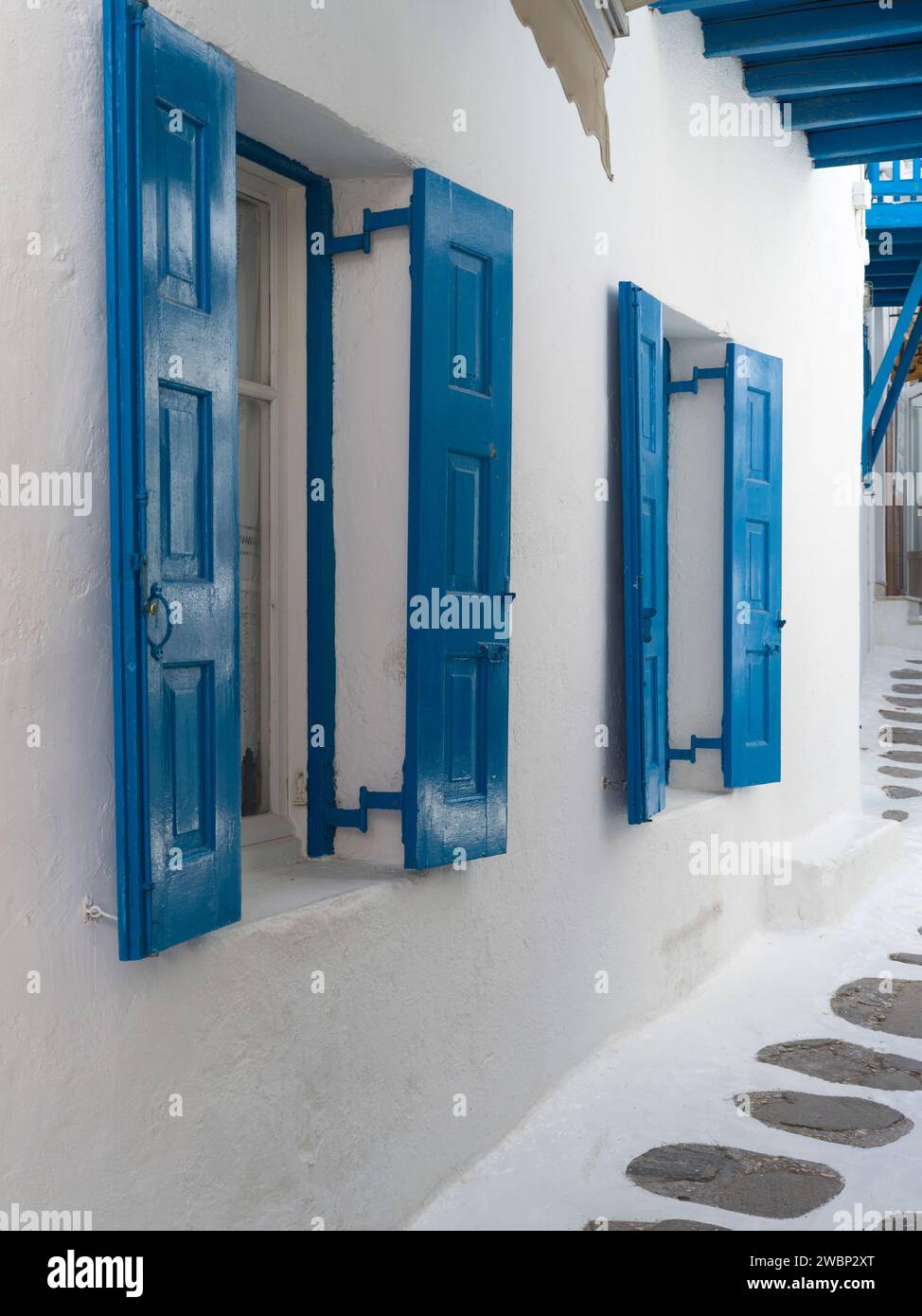 Blue shutters on windows in Mykonos Town, Mykonos, Greece Stock Photo