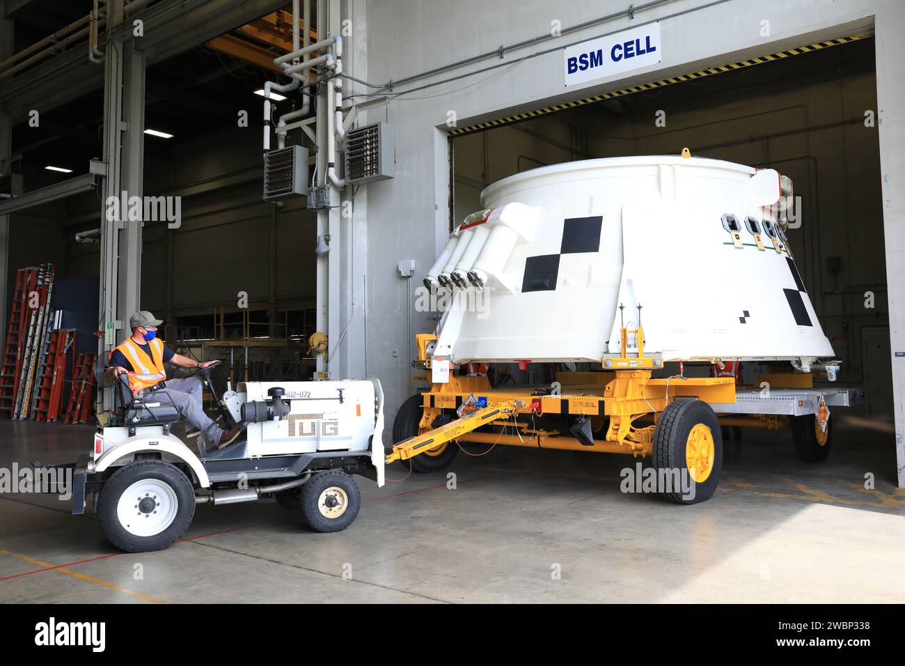 Inside the Booster Fabrication Facility at NASA's Kennedy Space Center in Florida, the Artemis I aft skirts for the agency's Space Launch System (SLS) rocket’s twin solid rocket boosters are being readied for their move to the Rotation, Processing and Surge Facility (RPSF) on June 9, 2020. In view, the left aft skirt assembly is attached to a move vehicle and moved out of a test cell. The aft skirts were refurbished by Northrop Grumman. They house the thrust vector control system, which controls 70 percent of the steering during initial ascent of the SLS rocket. The segments will remain in the Stock Photo