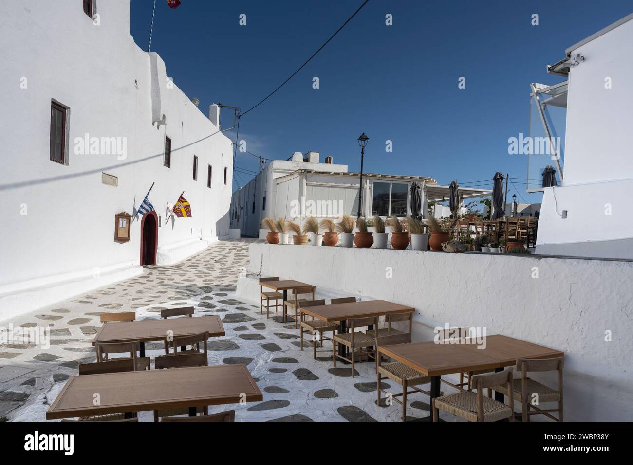 Tables and chairs on an outdoor patio, Mykonos Town, Mykonos Island, South Aegean, Greece Stock Photo