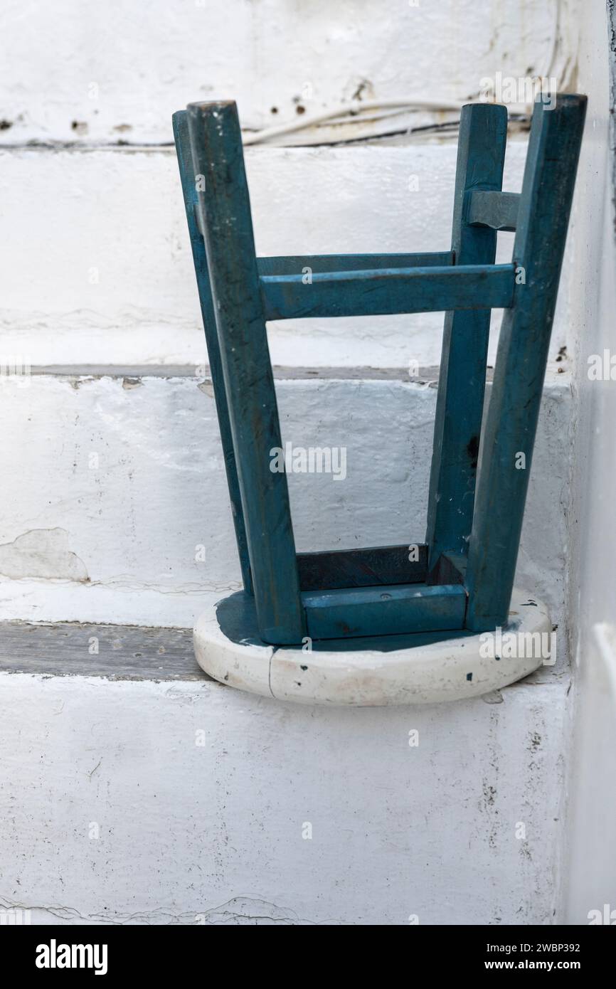 Stool placed upside down on a stairway, Mykonos Town, Mykonos Island, South Aegean, Greece Stock Photo