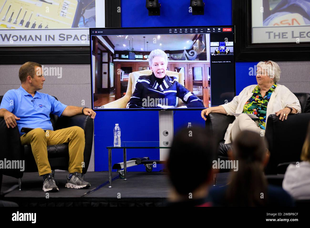 Tam O’Shaughnessy, center (on the monitor), speaks during “The Legacy of Sally Ride: The First American Woman in Space” event at Kennedy Space Center in Florida on June 15, 2023. O’Shaughnessy was Ride’s lifetime partner for 27 years, until the pioneering astronaut died in 2012 at age 61 from pancreatic cancer. NASA Chief Historian Brian Odom, left, and Bear Ride, Sally Ride’s sister, also participated in the event. Forty years ago, Ride made her trailblazing flight into space. She also was a physicist and a steadfast advocate for inclusion in STEM (science, technology, engineering, mathematic Stock Photo
