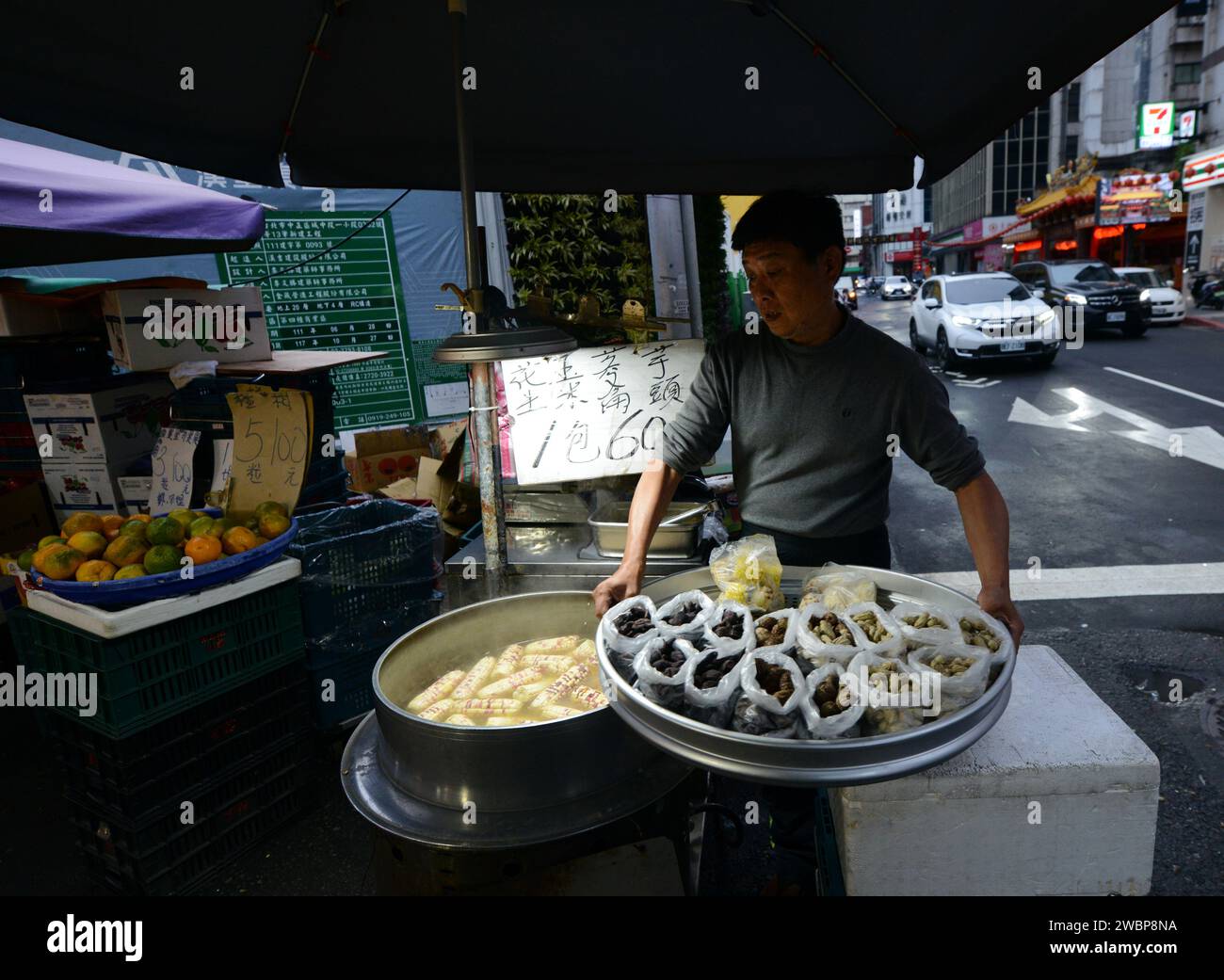 A corn and steamed groundnuts vendor at the Chengzhong Market in Taipei, Taiwan. Stock Photo