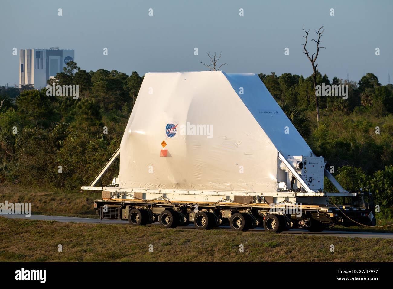 NASA’s Orion spacecraft, protected in its shipping container, is loaded onto a transporter at the Launch and Landing Facility at Kennedy Space Center for its move to the Neil Armstrong Operations and Checkout Building on March 25, 2020. After testing at NASA’s Plum Brook Station in Ohio verified it can handle the extreme conditions of a deep-space environment, the spacecraft – carried by the agency’s Super Guppy aircraft – has returned to the Florida spaceport for final testing and assembly. Following this, Orion will be integrated with the Space Launch System rocket for Artemis I – the first Stock Photo