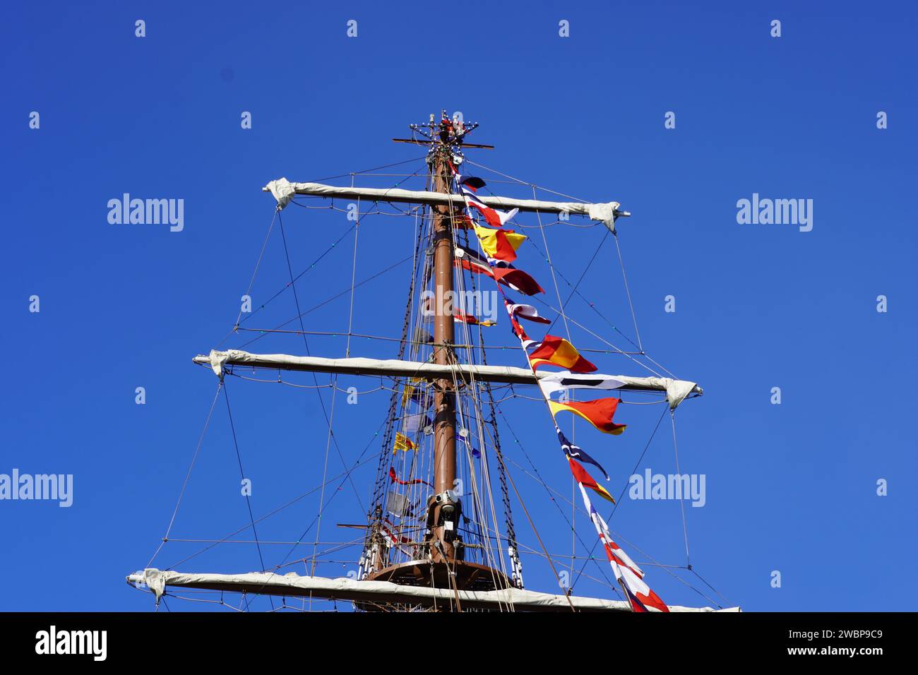 The front mast, sails and decoration flags of the BAP UNION, a sailing, training ship of the Peruvian Navy Stock Photo